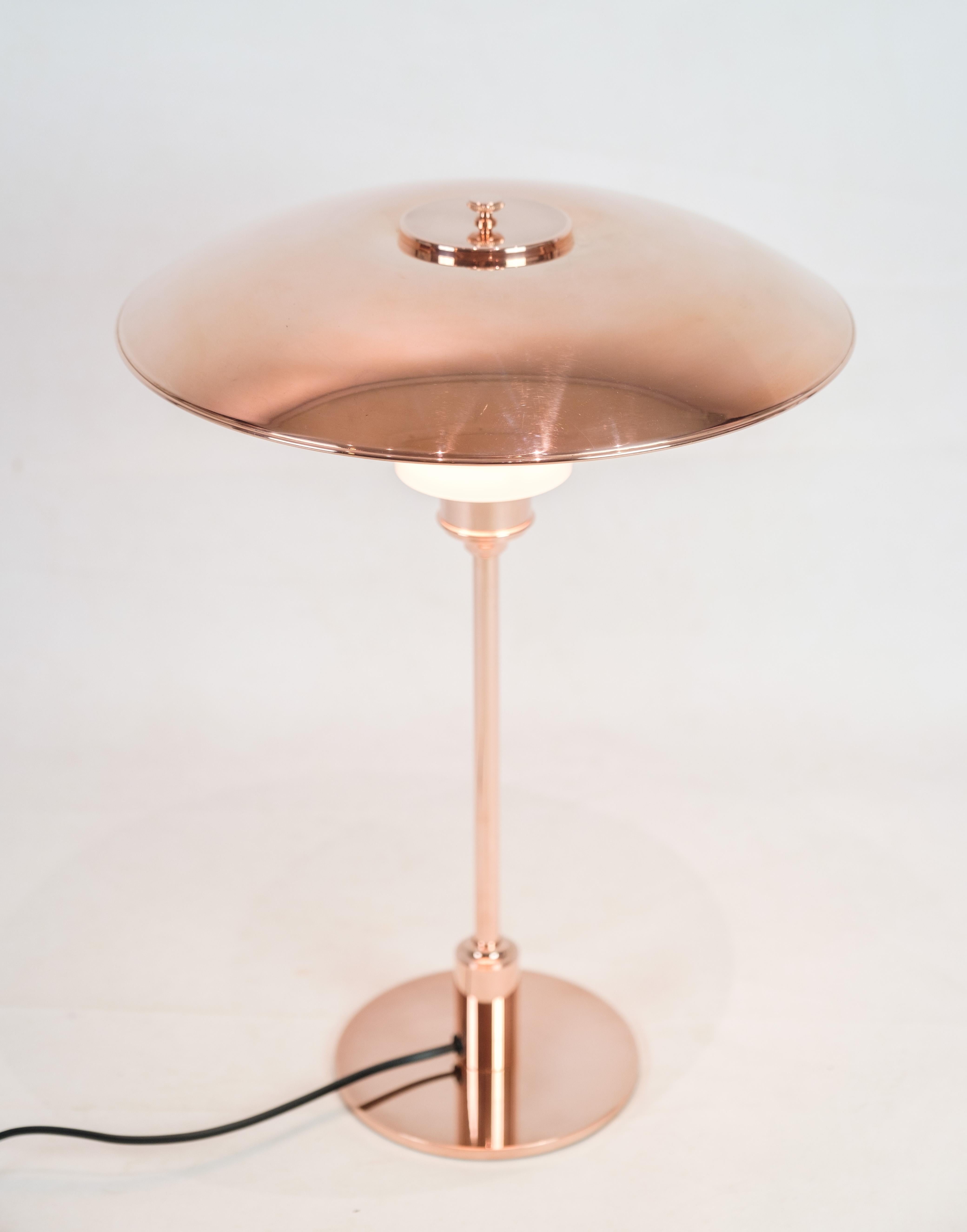 PH Table lamp, model PH3½-2½, limited edition, designed by Poul Henningsen and manufactured by Louis Poulsen. The lamp is made of copper with an upper shade in copper and two lower shades in white opal glass. An upper screen in white opal glass is
