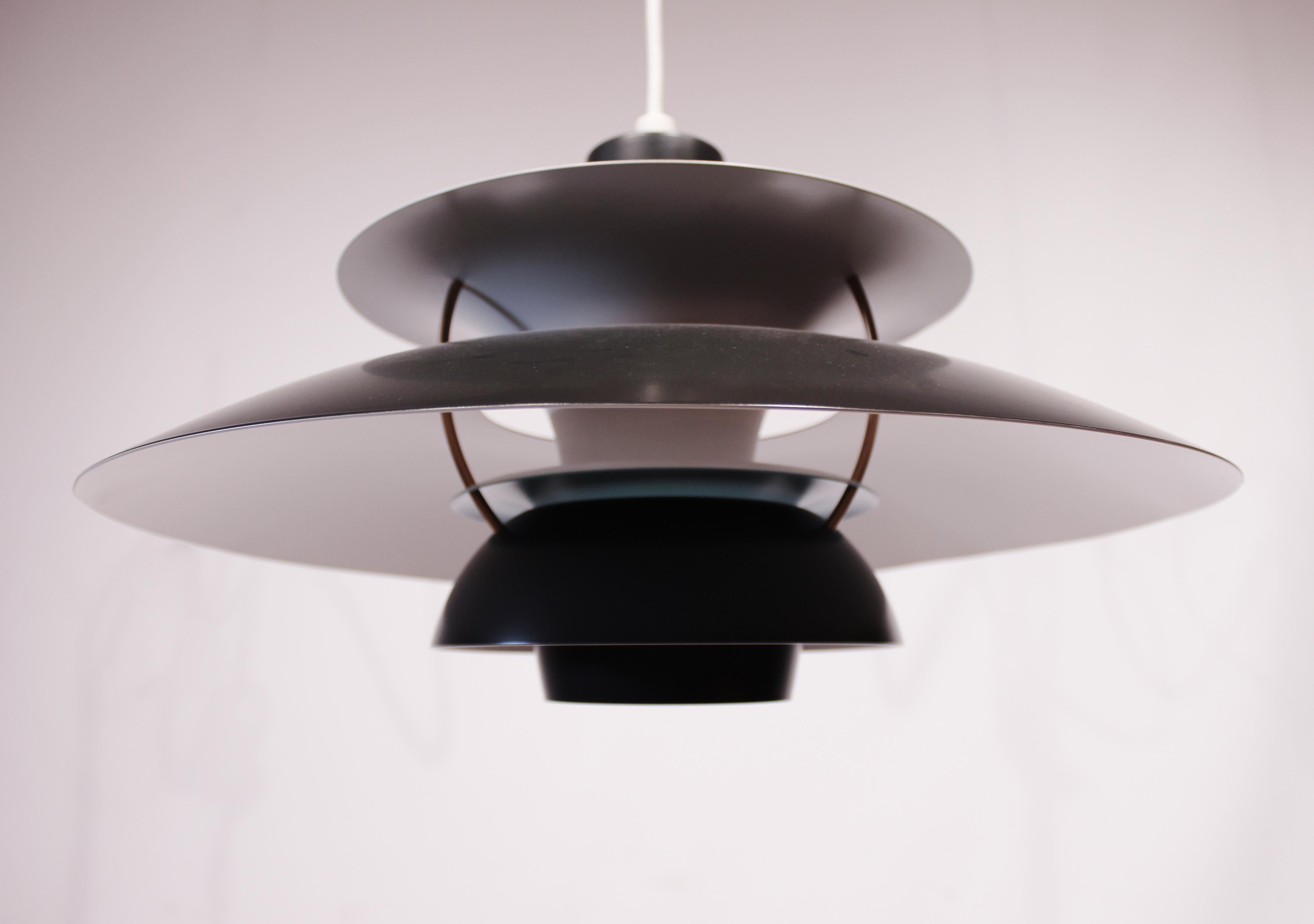 PH5 pendant designed by Poul Henningsen in 1958 and manufactured by Louis Poulsen. The pendant has dark grey lacquered metal Shades. And is of great vintage condition.
