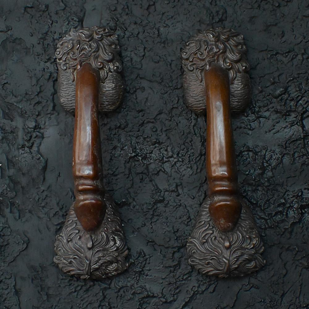 Phallus shaped bronze matched pair of cast door handles etched C. Kauna 1903
Dimensions in inches: H 12” x W 3.5” x D 3” 
Age: Early 20th Century
Origin: Austria
Condition: Aged
Overview
A matched pair of cast bronze phallus door handles by Carl
