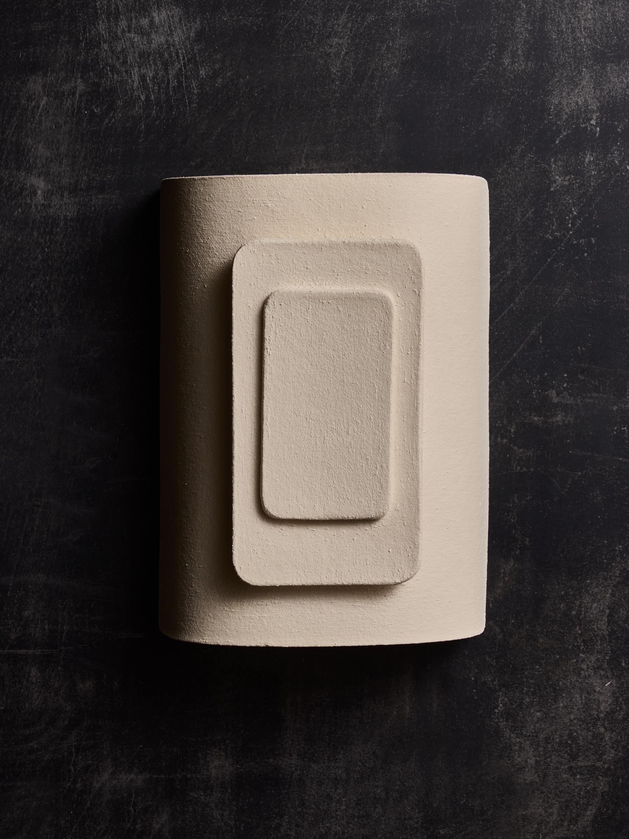 Phaos ceramic wall sconces made by the french contemporary artist Adeline Delesalle.

Curved main piece on which are layers of panels with spaces allowing the light to go through. Artist's signature on the back.

The sconces are sold without