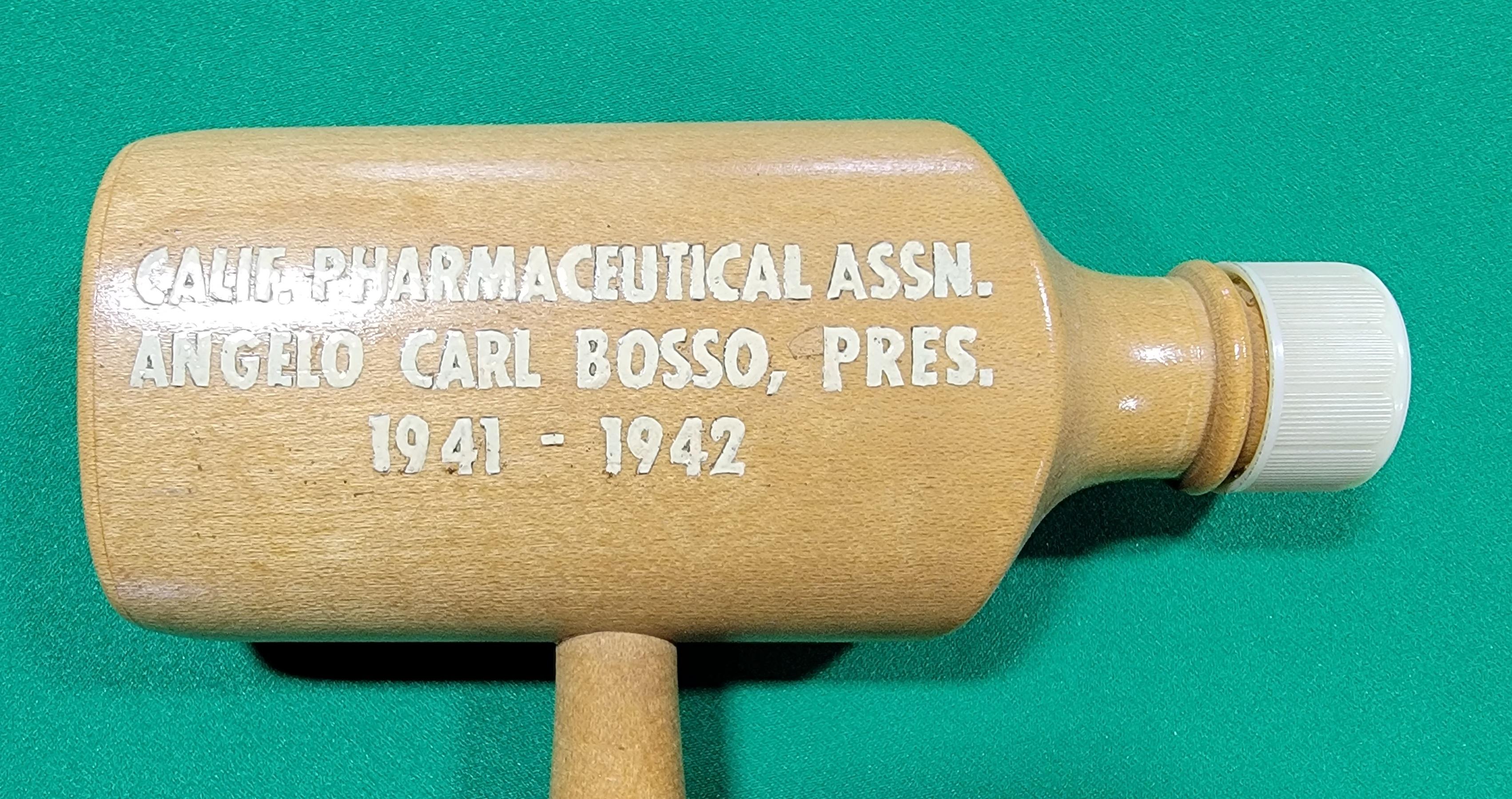Unusual ceremonial / presentation gavel presented to Angelo Carlo Bosso, president of the California Pharmaceutical Association 1941-1942. Turned wood in the form of medicine bottles with a Bakelite bottle cap. His pharmacy was located in San