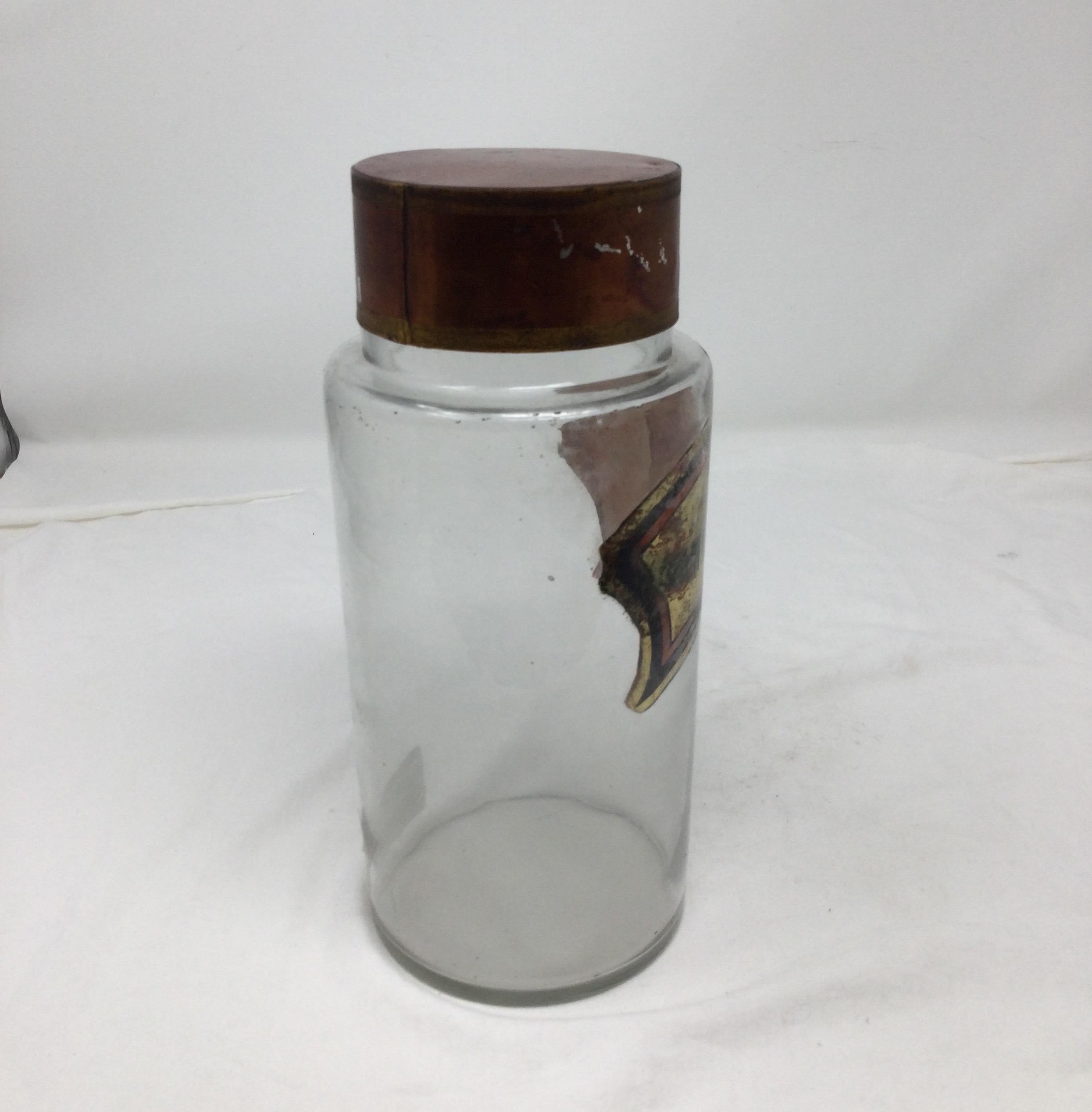 Antique pharmacy jar from France. Copper colored finish on lid. Label reading 