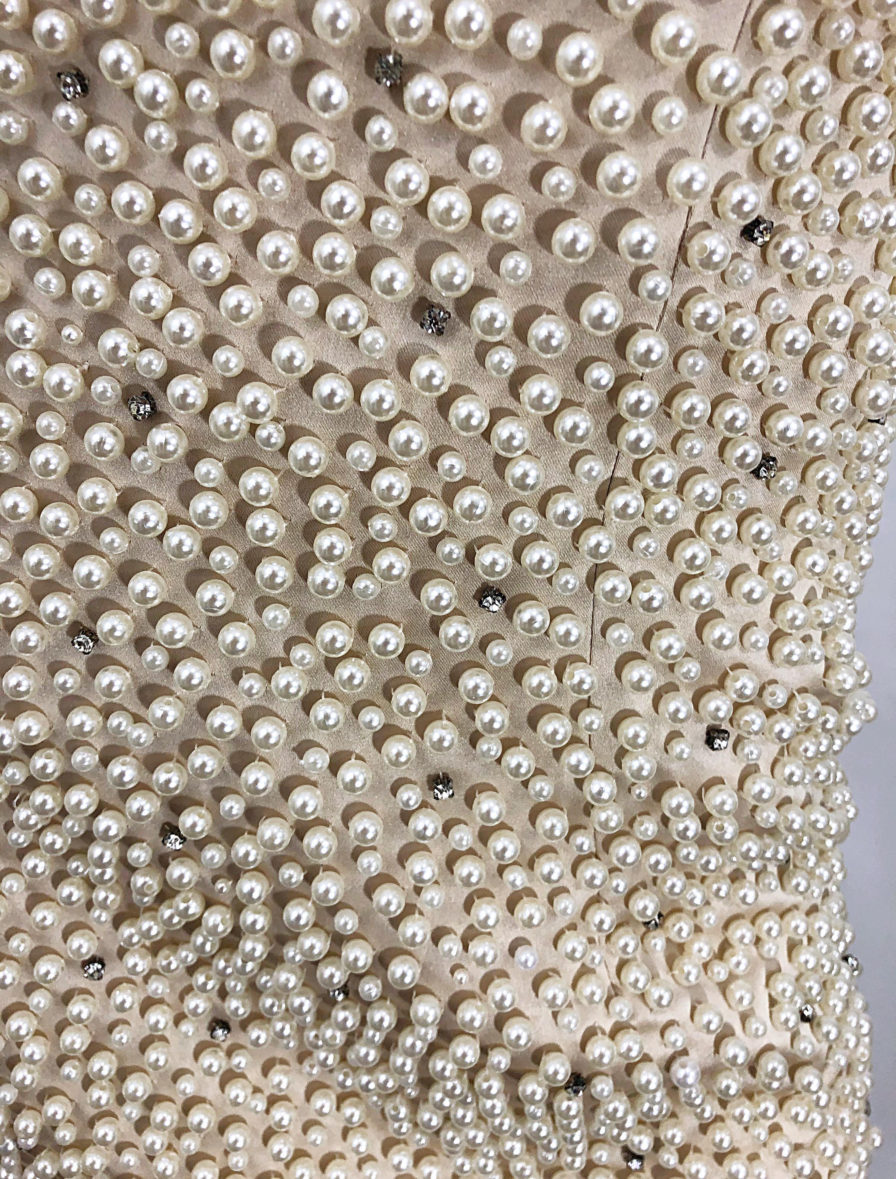 Phenomenal vintage late 80s pearl and rhinestone encrusted couture bodycon gown! Features thousands of 
hand-sewn pearls and rhinestones throughout. Built in interior support keeps everything in place. Nude chiffon overlay at legs. Couture quality