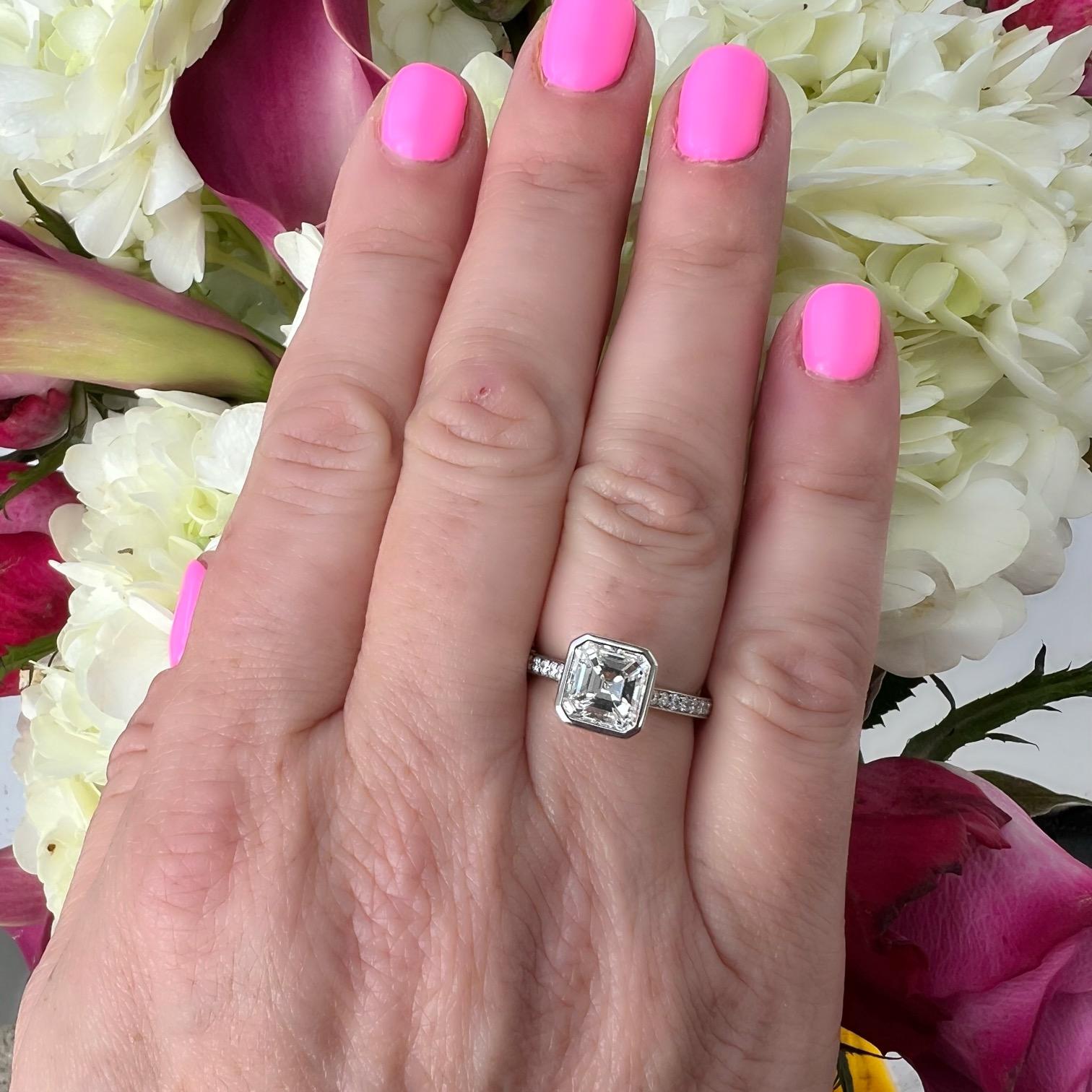 Get ready to turn some heads with this platinum beauty! This incredible custom engagement rings features a gorgeous 2.14 carat Asscher Cut Diamond (aka Square Emerald Cut) bezel set in a phenomenal platinum ring with an open basket showcasing every