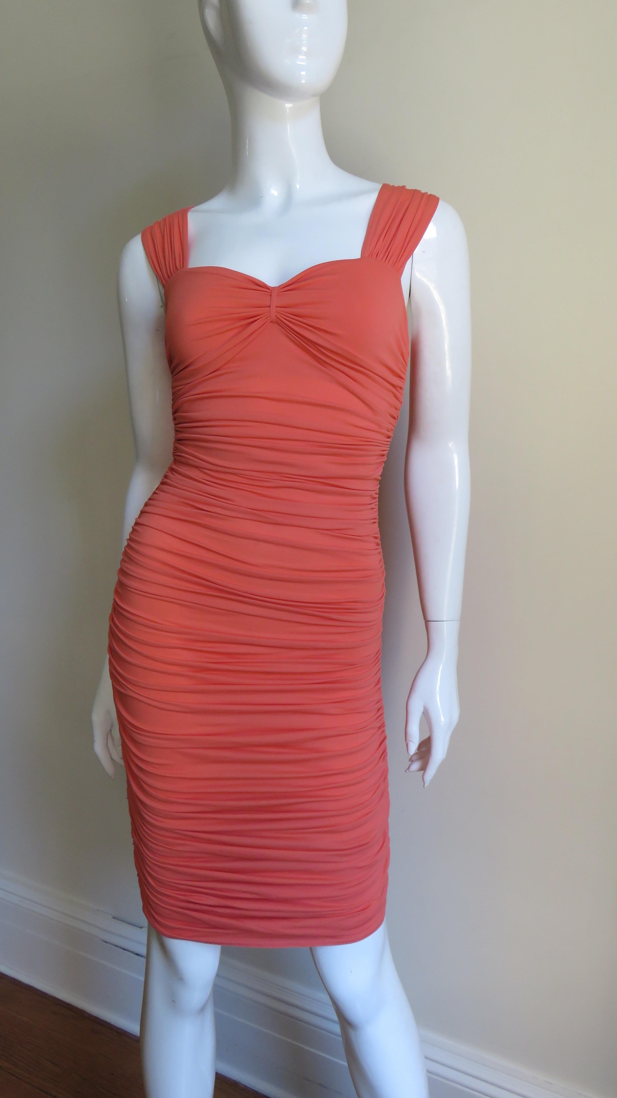 A beautiful ruched dress in melon colored jersey by Pheobe Philo for Celine. It is fitted, horizontally ruched around it's circumference the length of the dress with ruched shoulder straps.  It is unlined and has a side invisible matching zipper. 