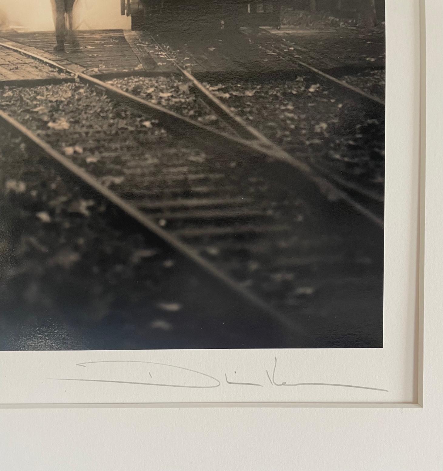 In The Yard, Train Yard With Worker Sepia Toned - Photograph by Phil Kember