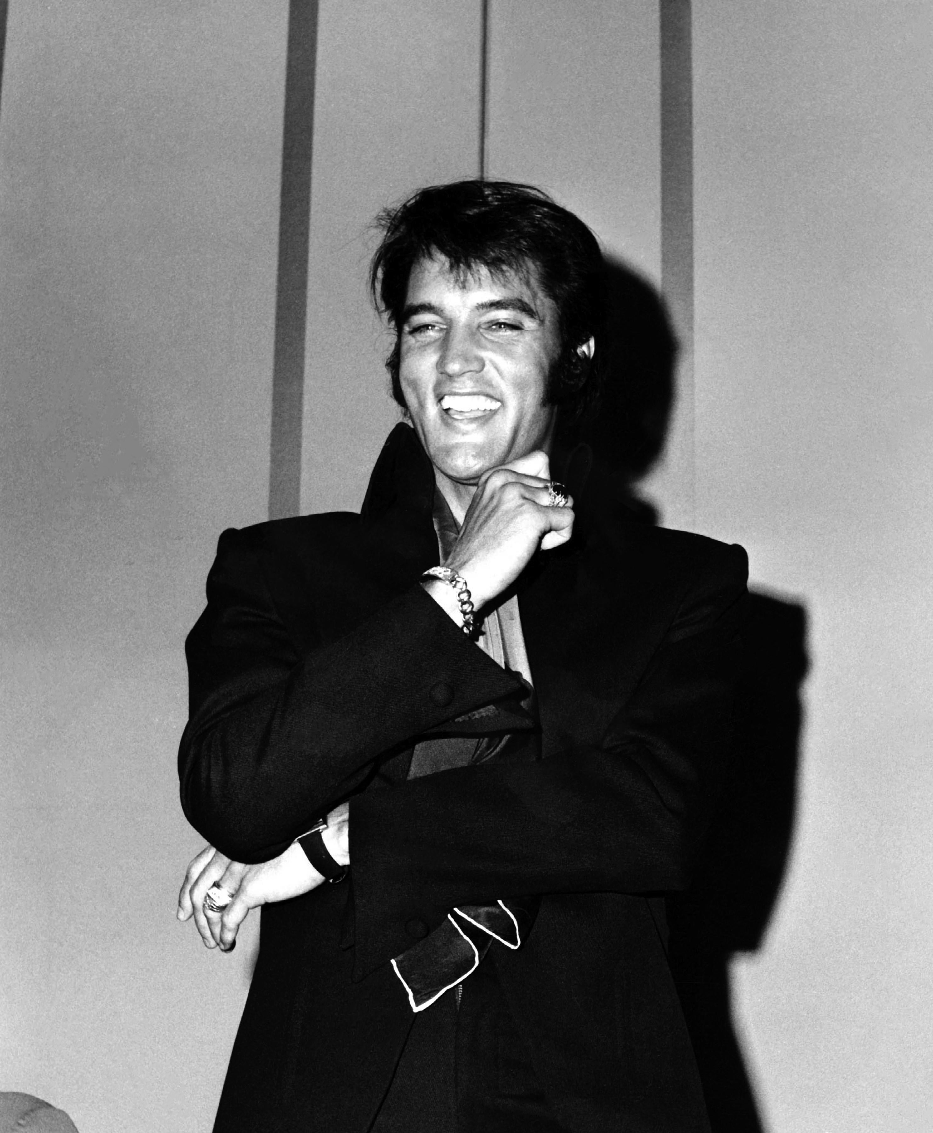 Phil Roach Black and White Photograph - Elvis Laughing at a Press Conference Fine Art Print