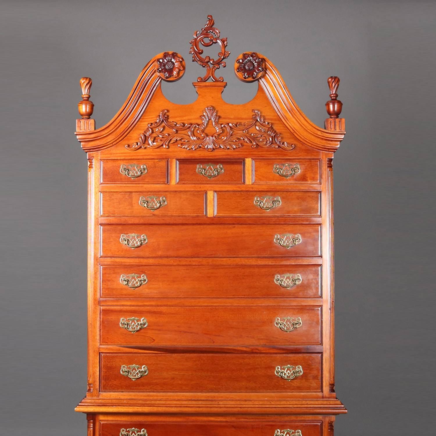 Philadelphia Chippendale School hand-carved mahogany chest on chest features scrolled broken arch pediment with scrolls having carved rosettes, central pierced cartouche and flanking flame carved finials, foliate and scroll work on crest,