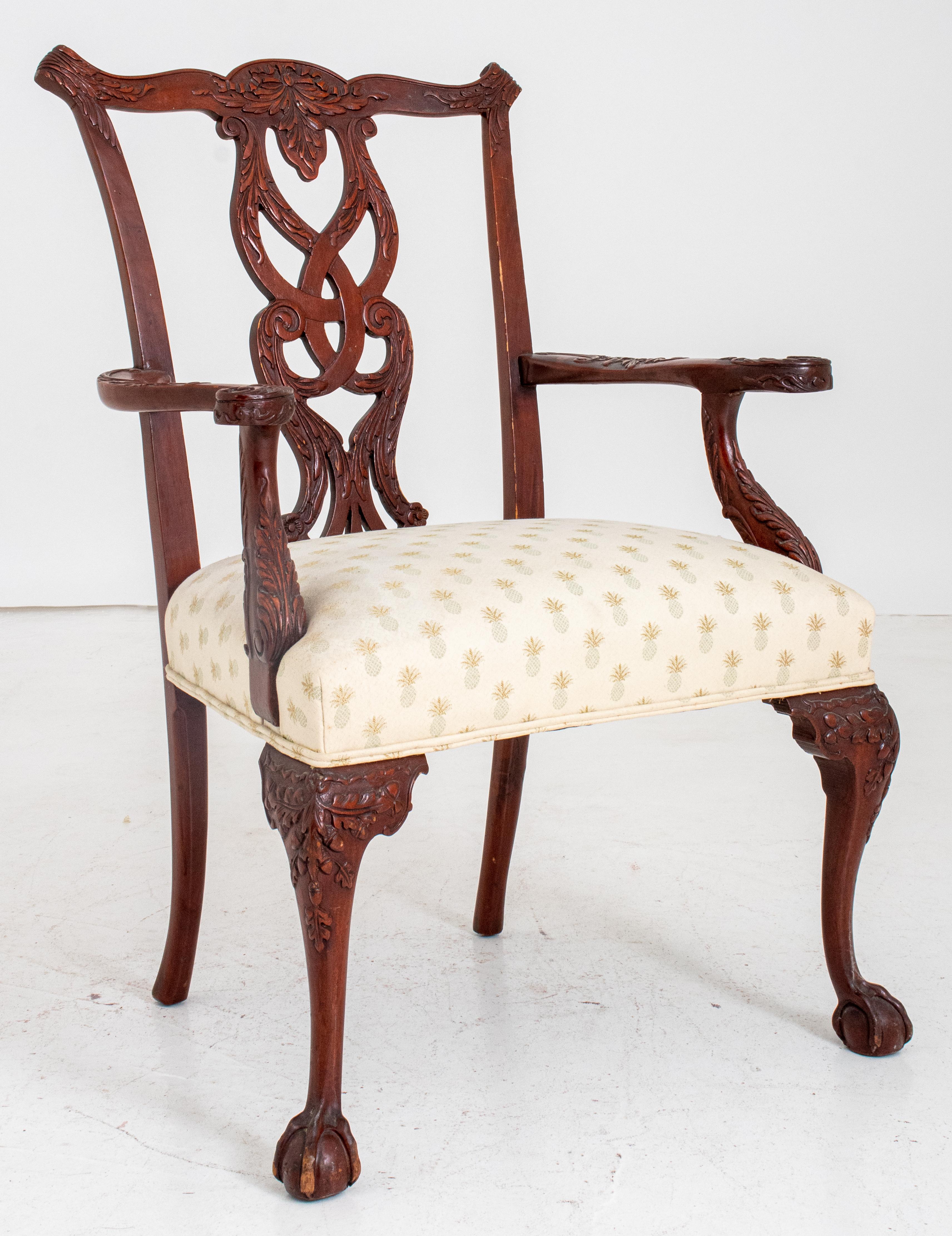 Philadelphia Chippendale style mahogany armchair with shaped crest rail above openwork leaf-carved backsplat with scrolling foliate-carved arms above a rectangular upholstered seat on carved cabriole legs, the front two terminating in claw and ball