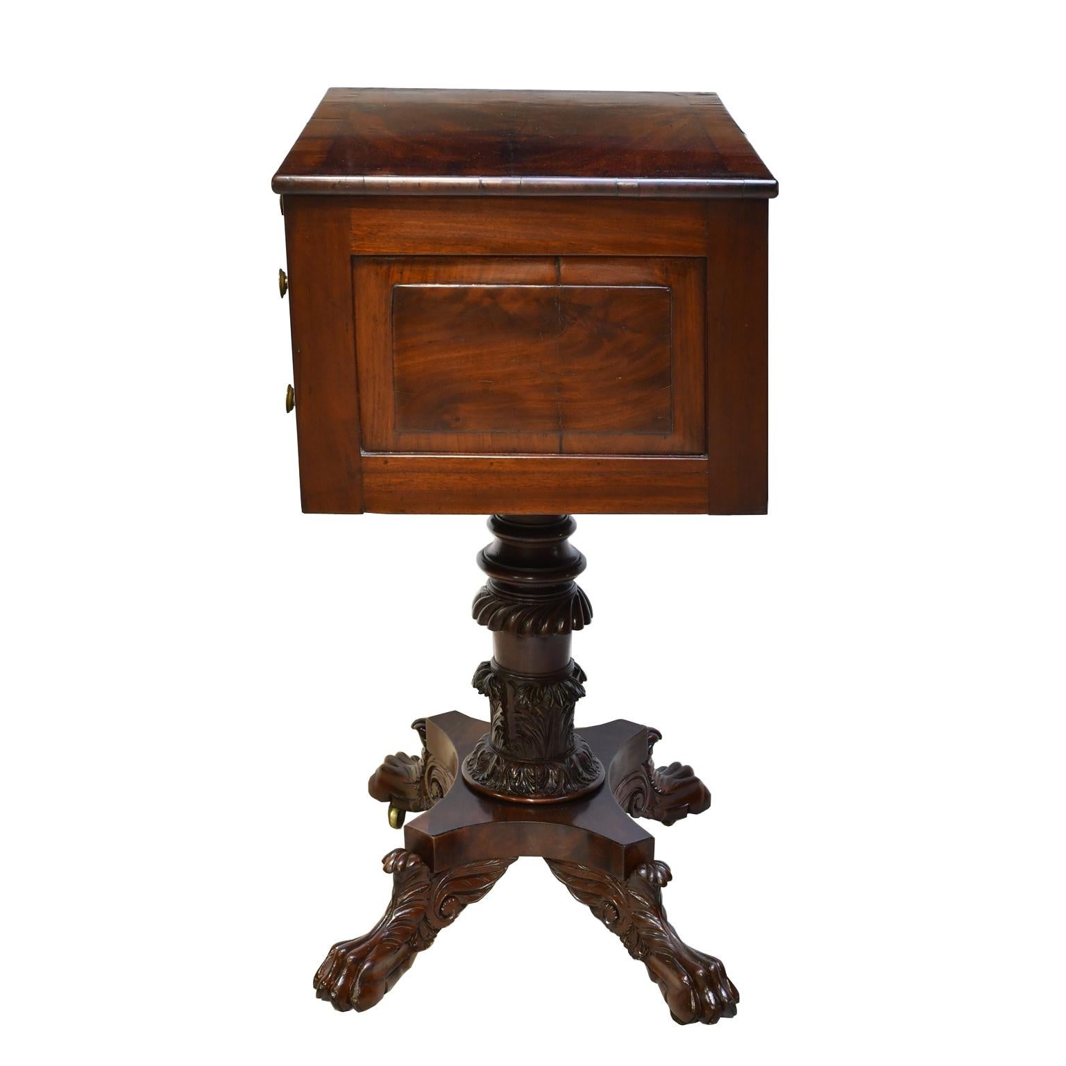 A stunning American Federal table in mahogany with neoclassical form in the manner of renown Philadelphia cabinetmaker Anthony Quervelle. Top offers three convex drawers and rests on turned and intricately-carved column over a quatre-form base that