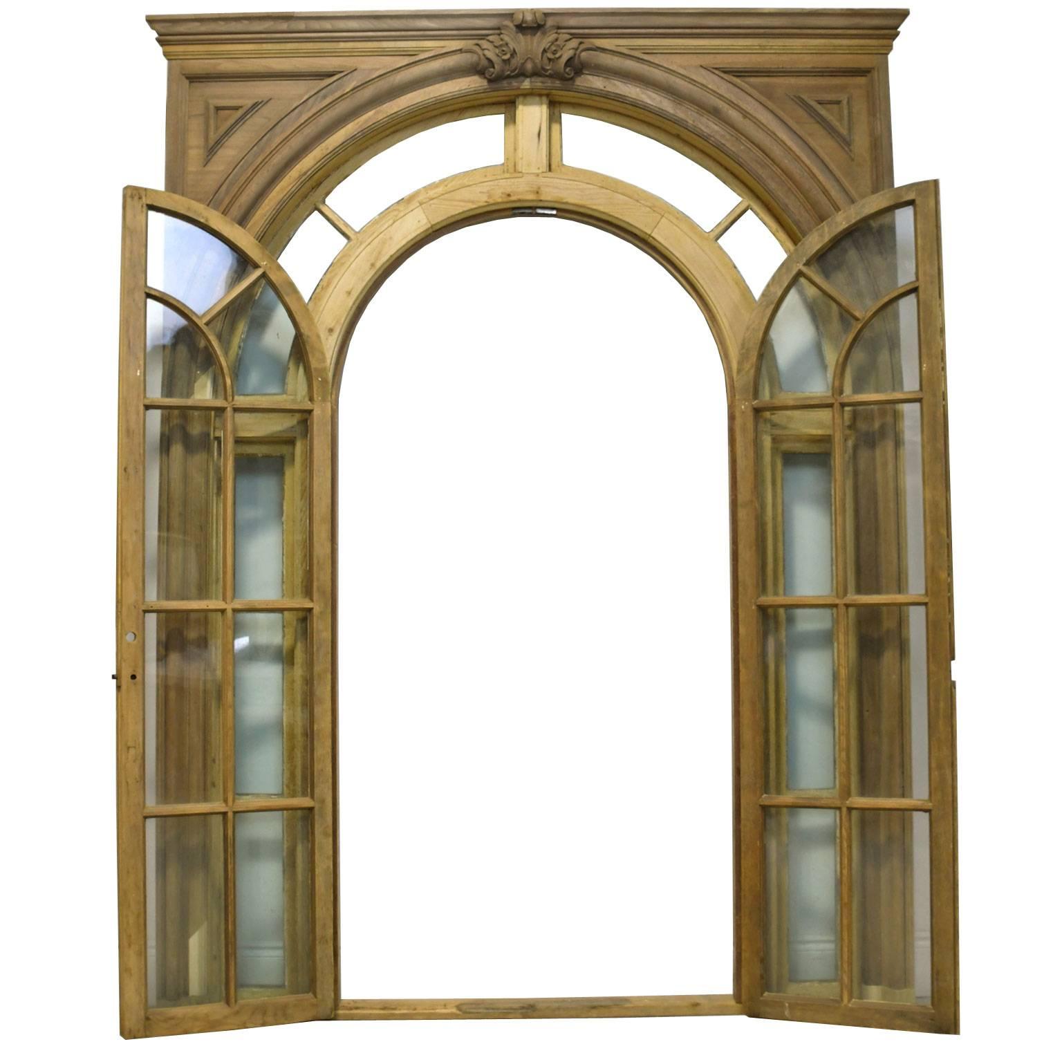 From the American Federal period, a magnificent pair of arched doors with glass light surrounds and with finish moldings on both sides in the elegant neoclassical style that was so prevalent at the time. Features original antique glass.
