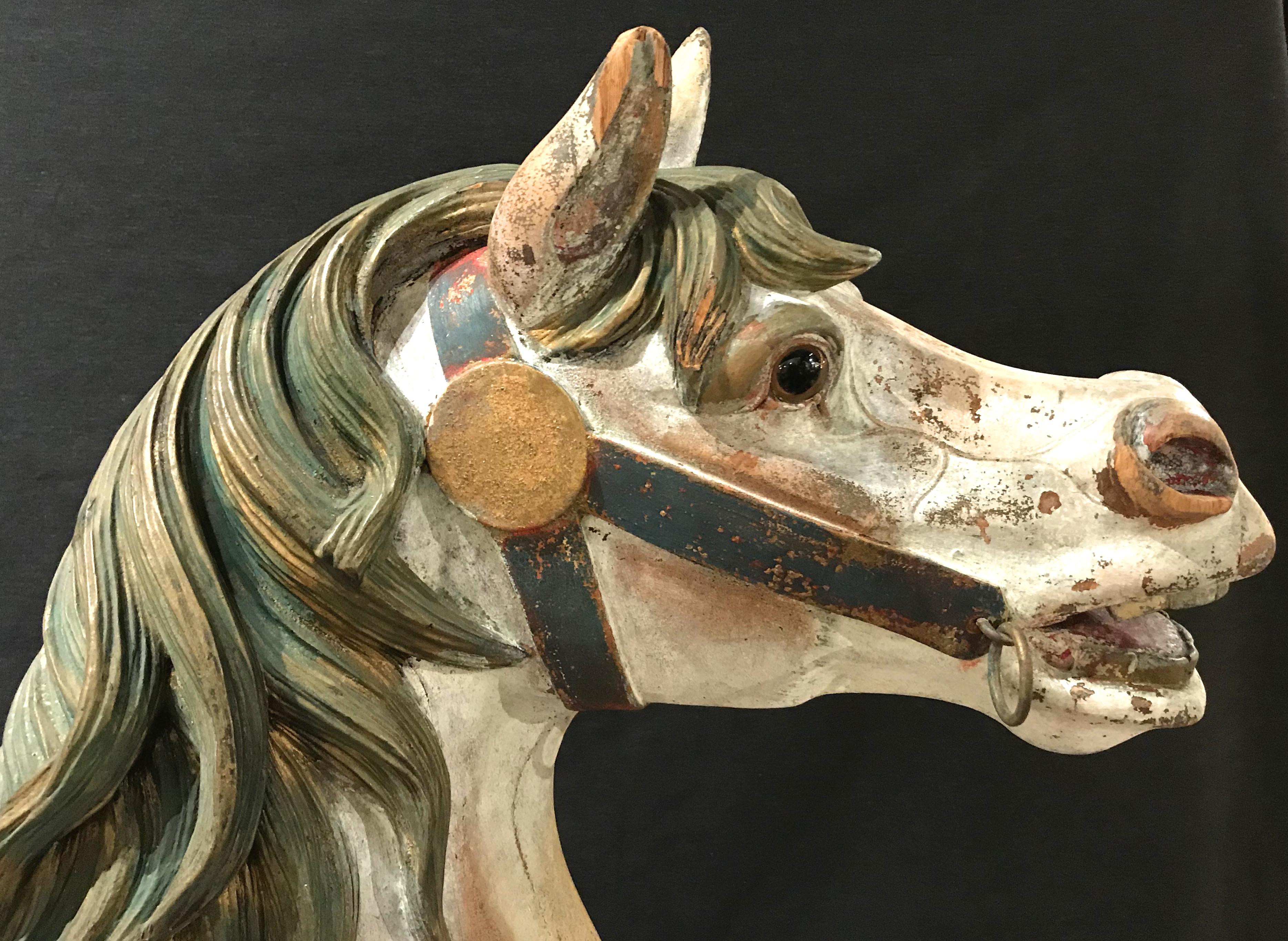 A fine example of a polychrome hand carved wooden carousel horse by the Philadelphia Toboggan Company. This was a second row horse with glass eyes and a real horse hair tail. The horse is in very good overall condition, with some of its original