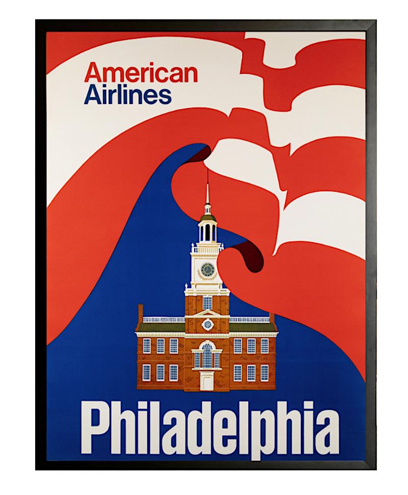 This is an original American Airlines travel poster from the 1960s advertising Philadelphia as one of their alluring destinations. The poster boldly displays the Independence Hall, with a flowing American flag behind and around it. Originally issued