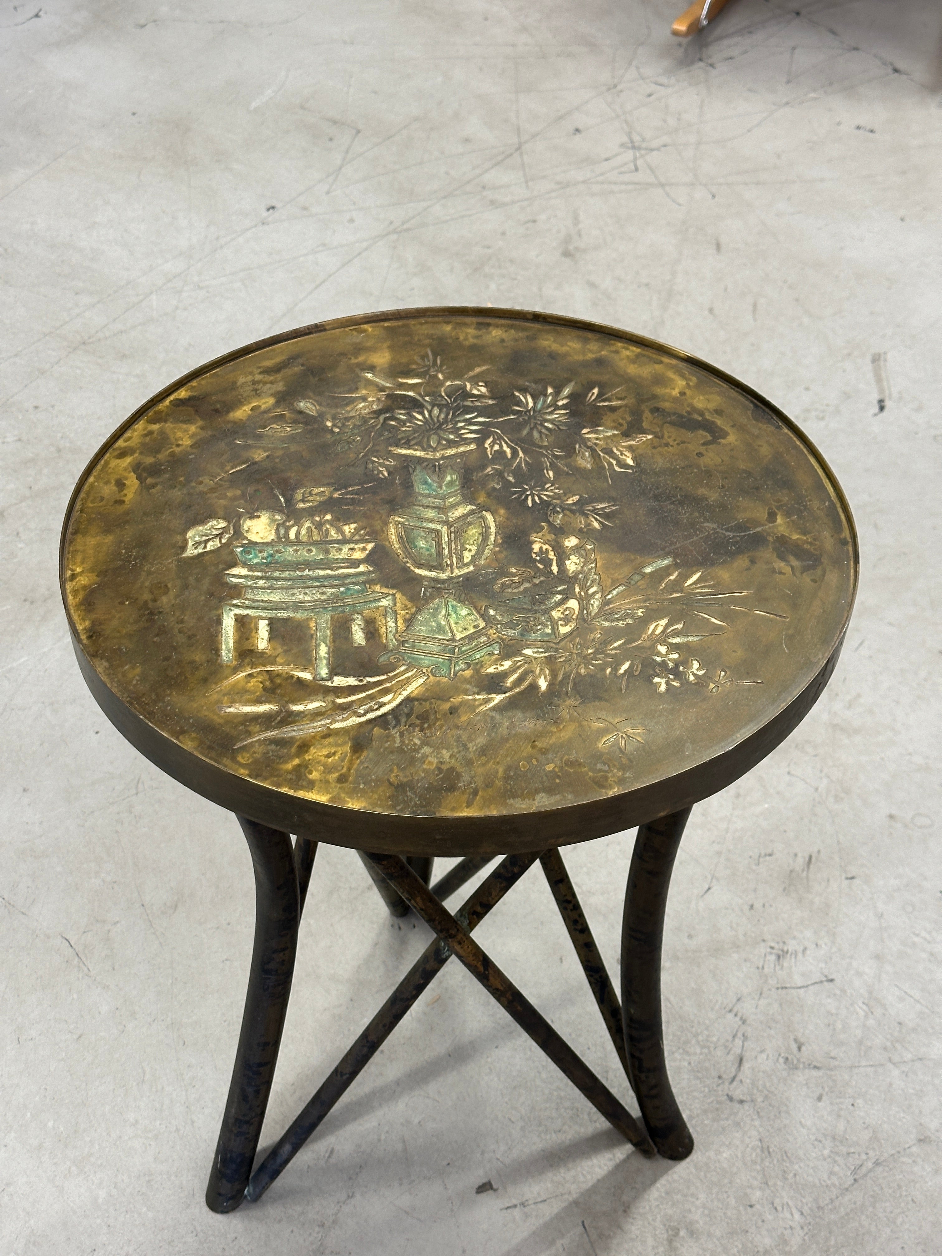 A beautiful and unusual example of an acid etched table by Philip and Kelvin LaVerne. This diminutive beauty has a floral motif and beautiful patina. It’s held up by tubular legs. In good condition with a small bend to a spot on the rim, pictured.