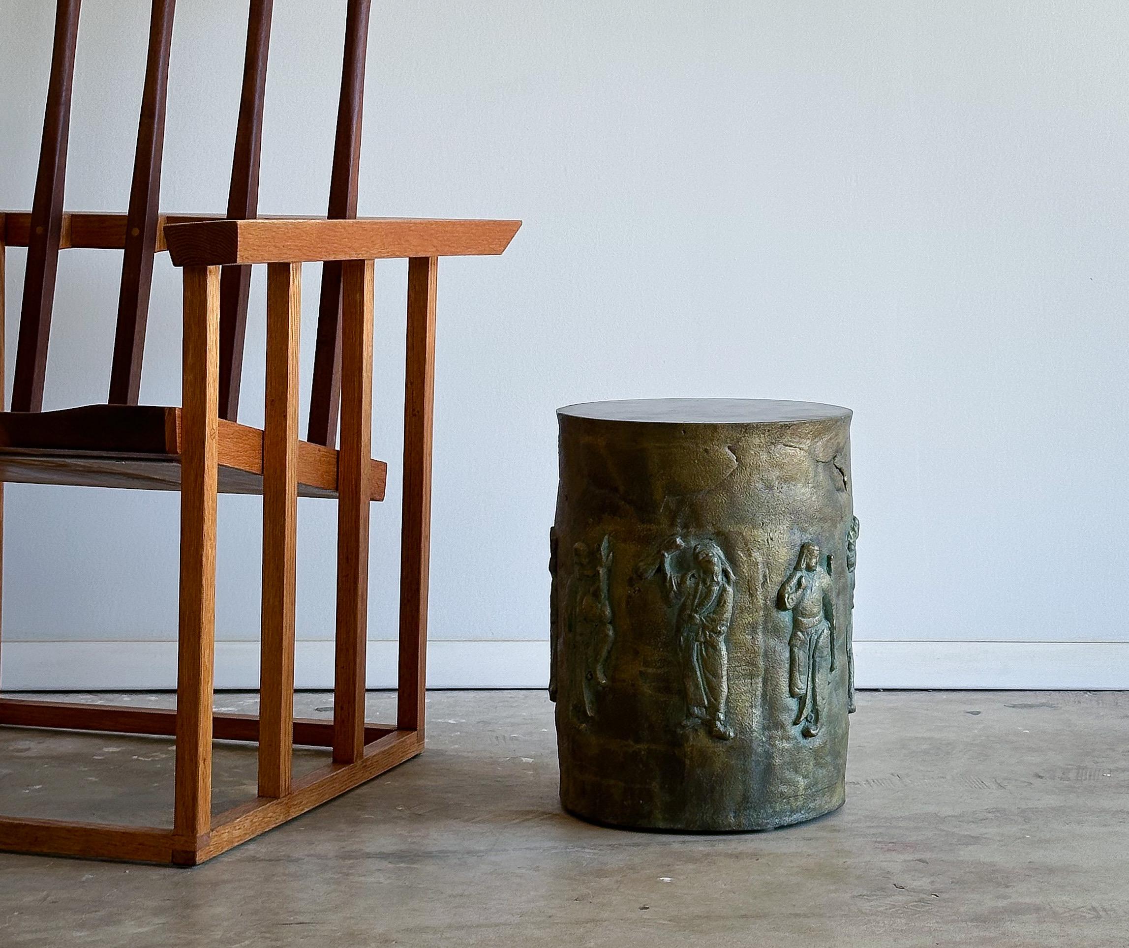 A rare side or end table made by famed father and son artist duo Philip and Kelvin Laverne. 

A functional piece of art made from patinated bronze and pewter. It features eight different and unique human subjects in high relief ranging from a