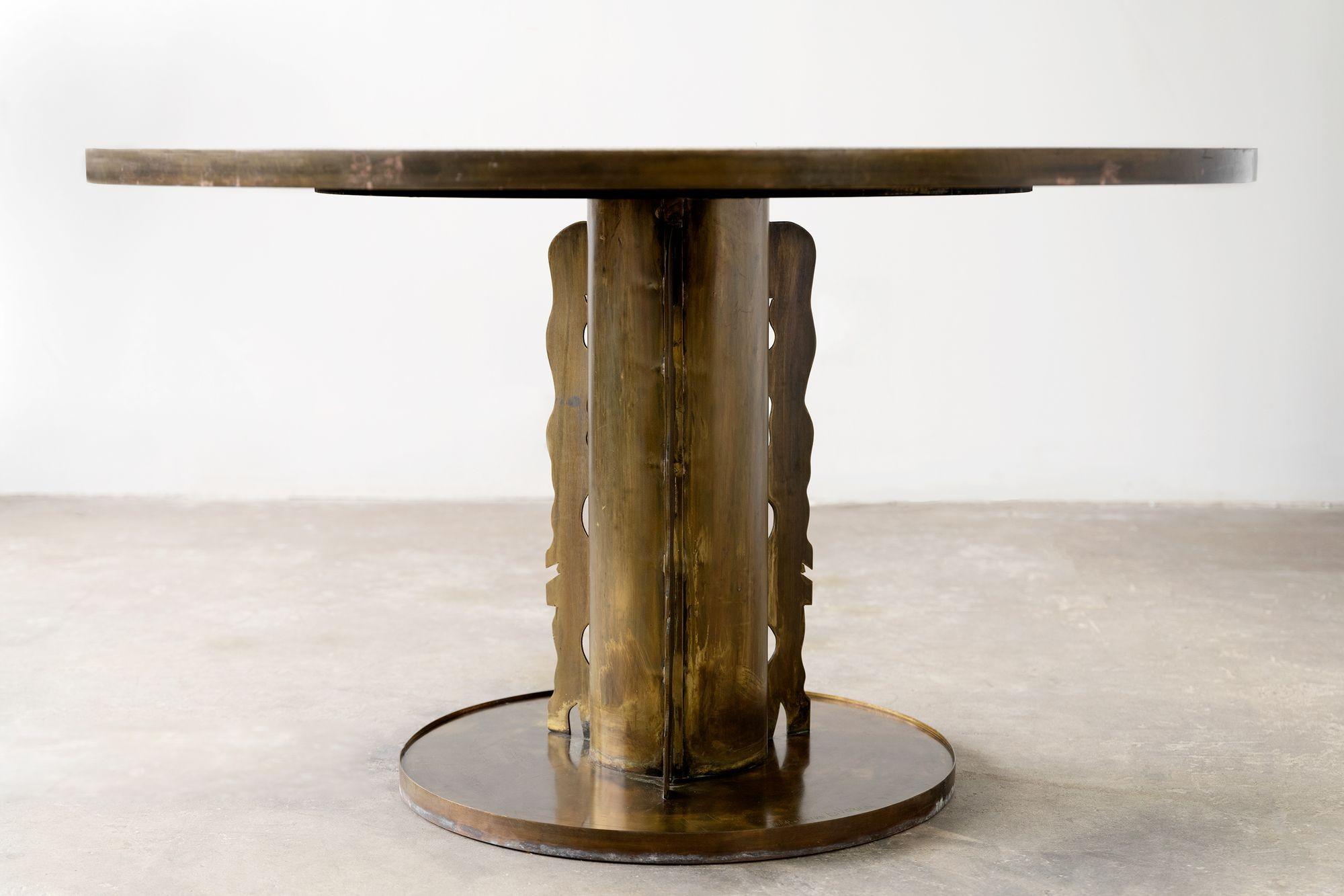 Etruscan dining or game table designed by Philip and Kelvin Laverne. Bronze forms embedded in pewter create a pattern reminiscent of ancient Etruscan artistry. The bronze pedestal is embellished with sculptured abstract forms adhering to the column