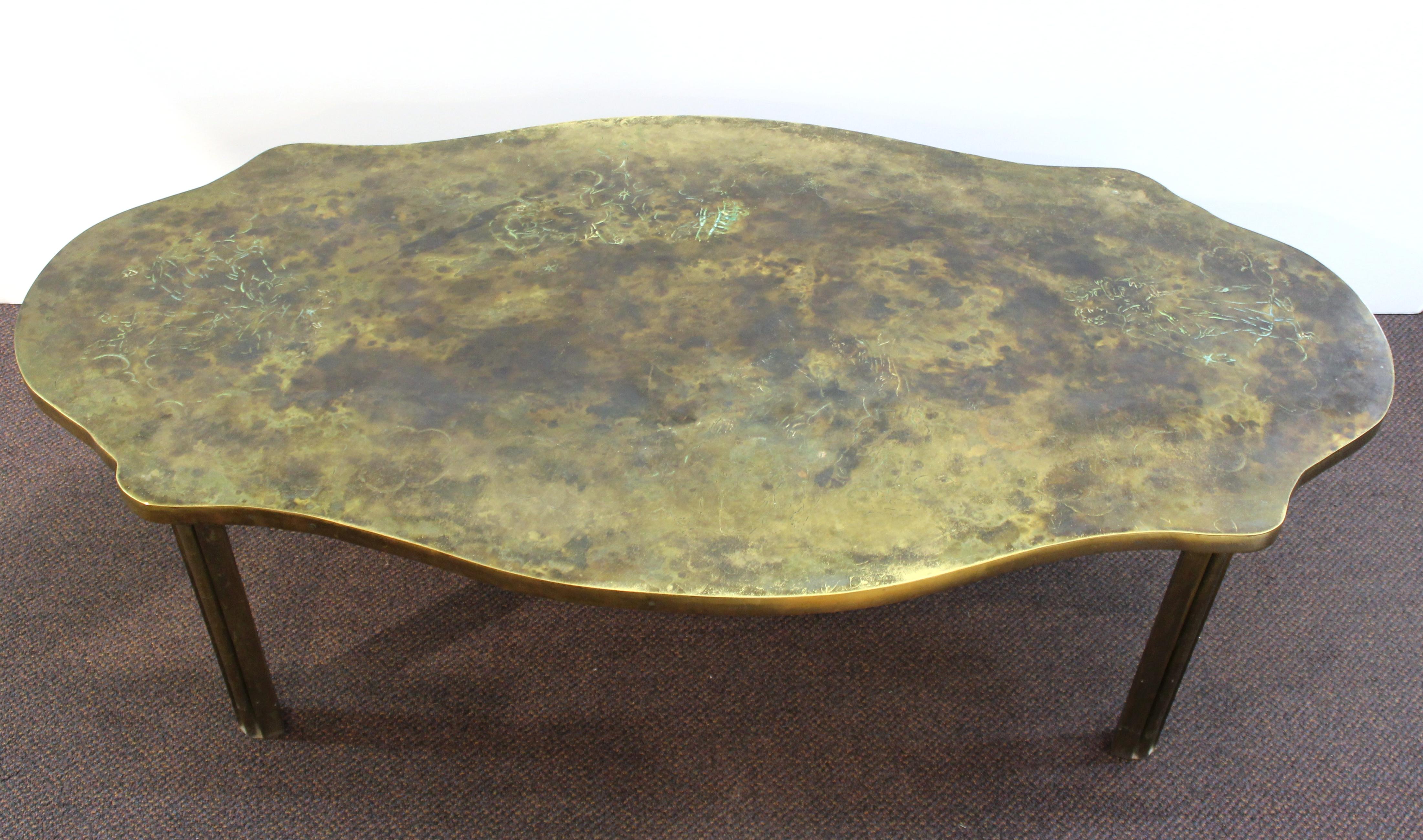 American Mid-Century Modern oval coffee table made in etched bronze by designers Philip and Kelvin LaVerne during the mid-20th century. The piece features etched muses of classical inspiration on the top surface and has an etched signature on one of