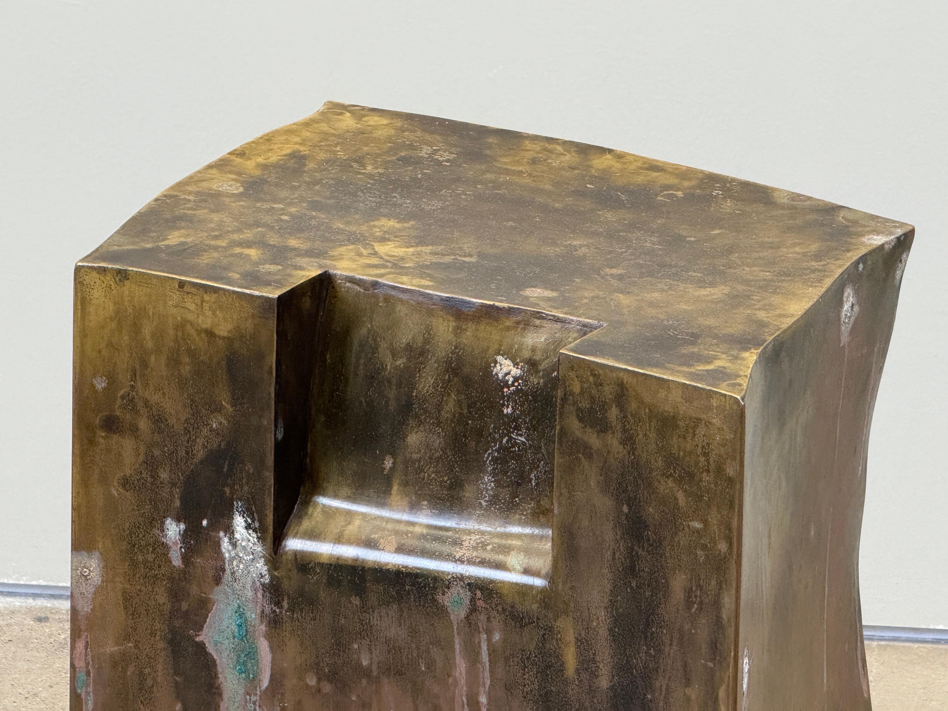 A rare and possibly unique work by Philip and Kelvin Laverne.  Titled 'Yielding', this sculpted table sits on casters and is weighted so it can be used as a stool as well. Patinated with some corrosion to bronze as seen in photos. 