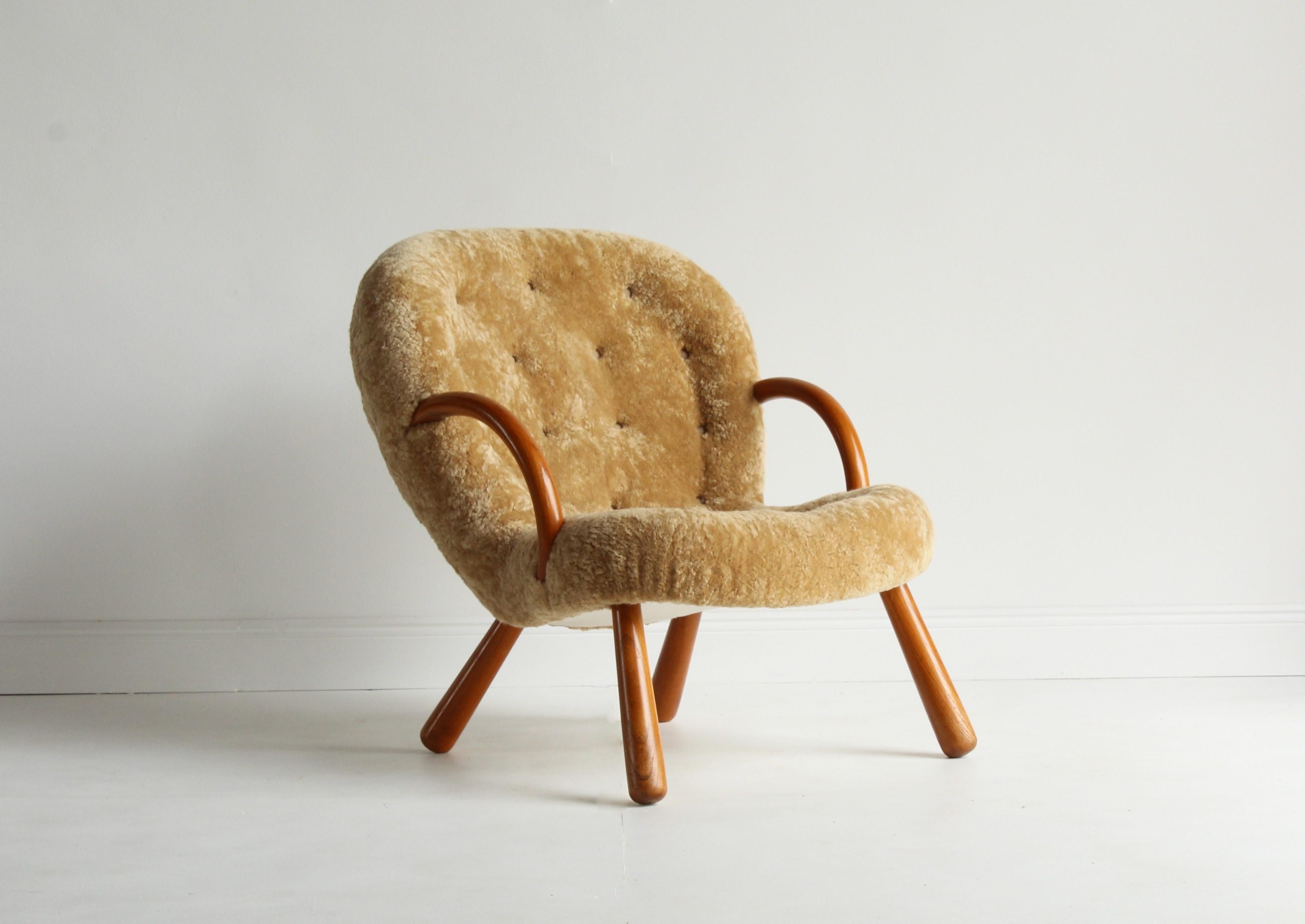 An unusual organic Philip Arctander lounge chair / clam chair. Stained beech frame, upholstered in natural beige sheepskin / lambskin.

Other designers working in the organic style include Peder Moos, Finn Juhl, Carlo Mollino, Gio Ponti and Jean