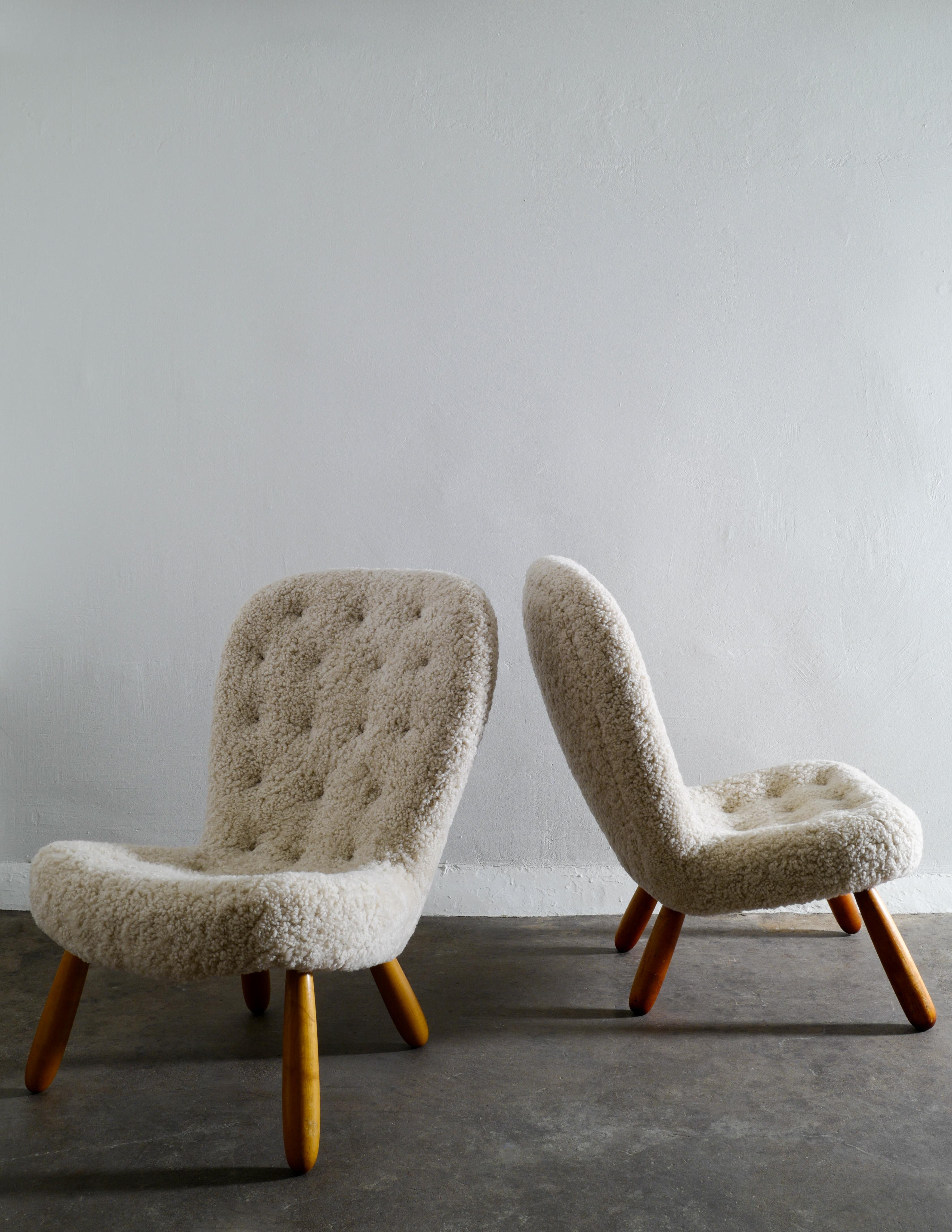 Rare pair of clam chairs by Philip Arctander produced in Denmark in the 1940s. Both chairs have newly been restored and upholstered in an 