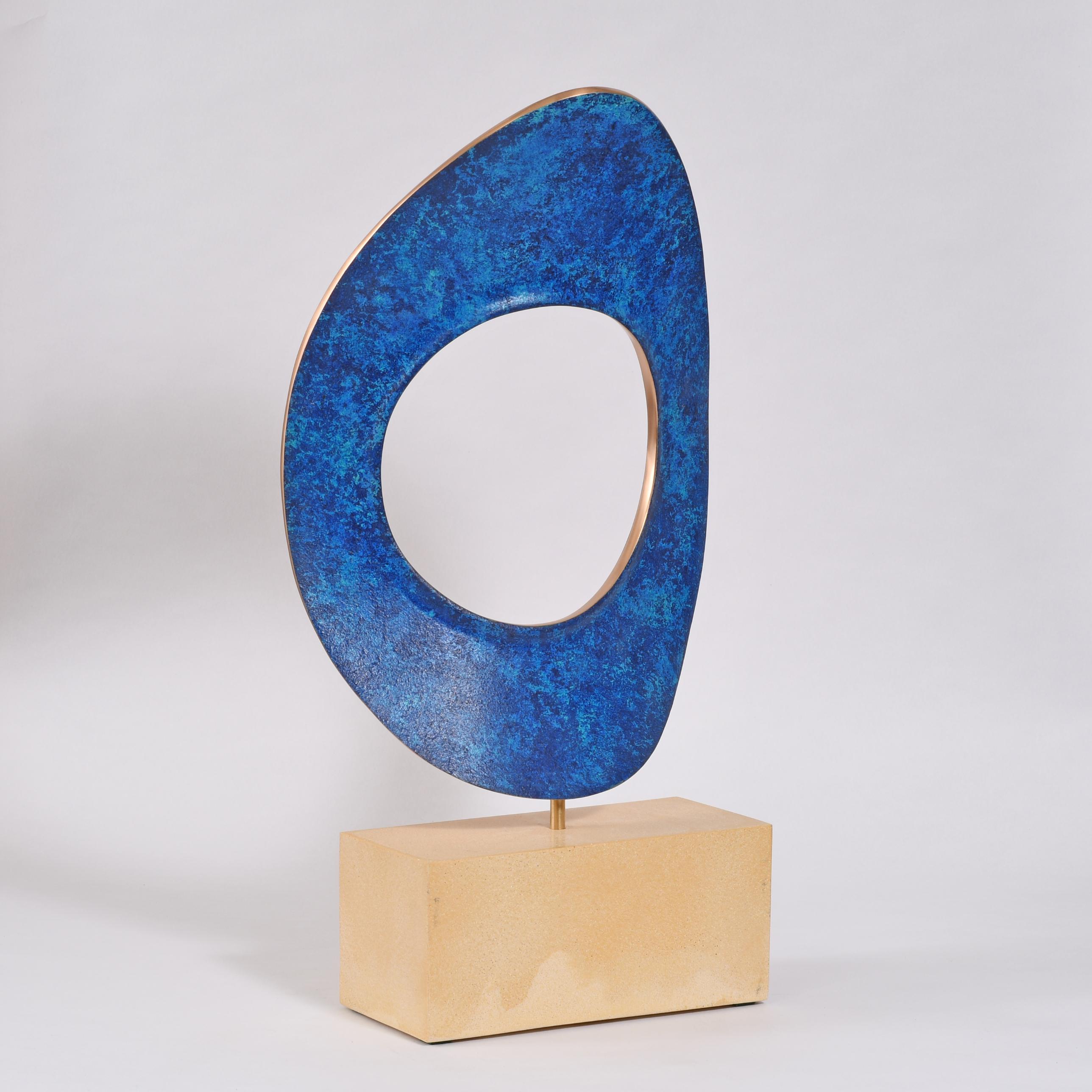 Bronze rotating on a composite base
Unique
Stamped with monogram signature and uniquely numbered 800A
Natural bronze shows on the edges and is lacquered for protection.
One face has an even mottled blue colouring whilst the other is more variegated