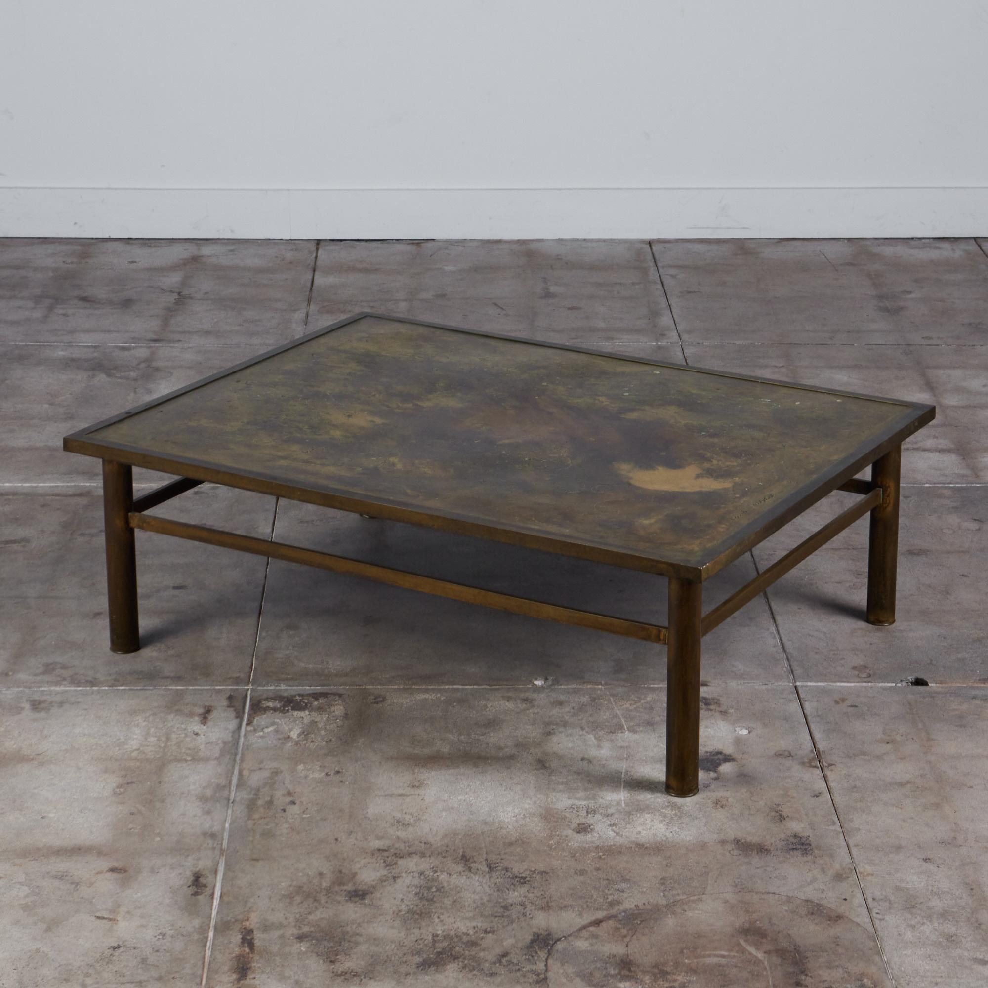 A highly collectible acid etched bronze coffee table by Philip and Kelvin Laverne. The rectangular shaped table features their 