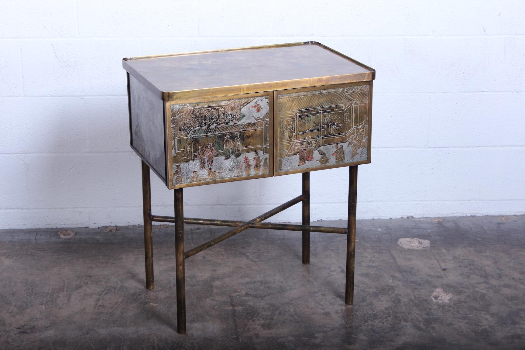 A small scale enameled brass two-door cabinet / bar by Philip & Kelvin Laverne.