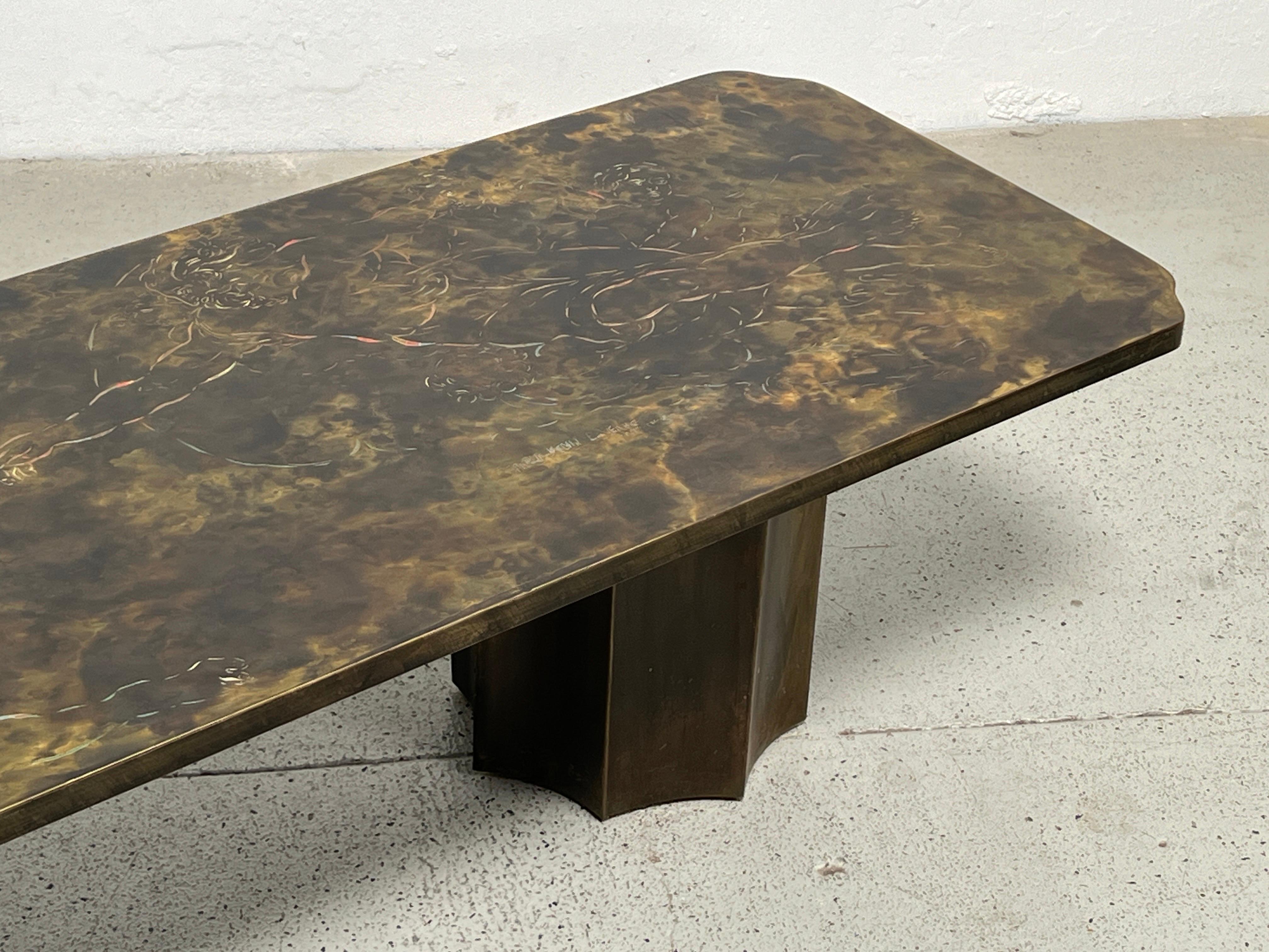 A large incised and acid etched patinated bronze coffee table depicting the creation of man by Michelangelo . Supported by two fluted column bases. Signed Philip and Kelvin LaVerne.