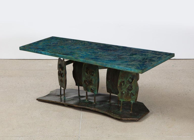 “Dance of the Fauves” Low Table by Philip & Kelvin LaVerne. Studio made bronze sculptural table with poly-chromed top. One of only two examples known to have been made in this size. 5 lower panels, each with welded relief shapes applied. Enameled