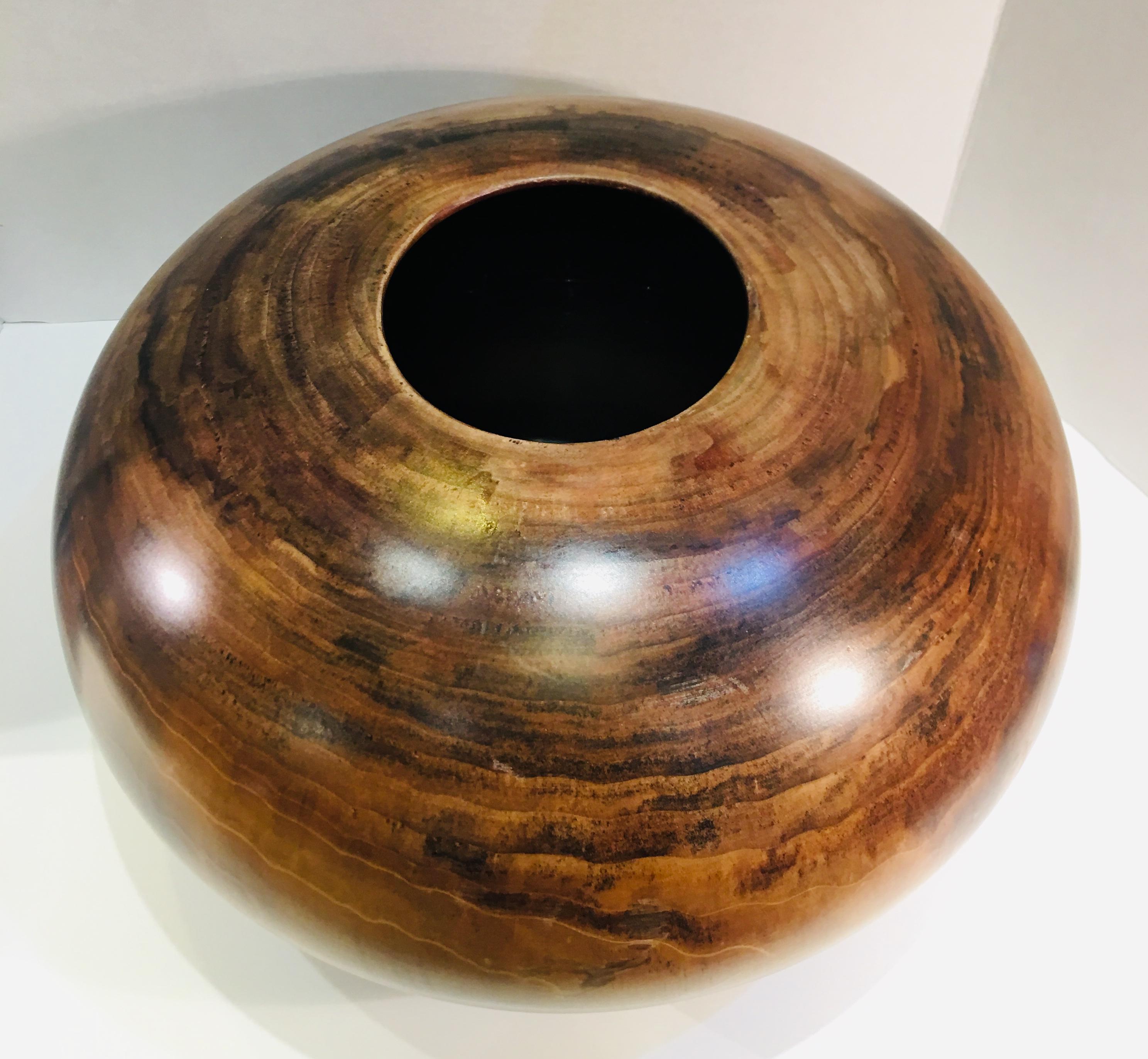 Handsome, handmade wooden bowl is a museum quality work of art that took many months to create. It is impressively large, measuring 9 inches high x 15 inches in diameter.

Signed, 