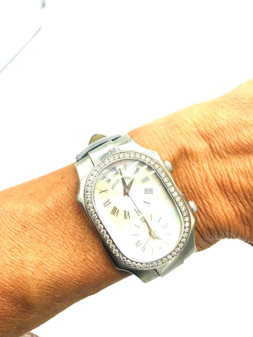 Philip Stein Signature Watch. Diamond 2-Time Zone Watch
VS quality diamonds. Mother of Pearl Dial. Black original strap, 9.5 inch total length. Face of watch is 2 inches x 1 -1/2 complete
Genuine Lizard strap. Water resistant to 3 ATM.
Feel Good