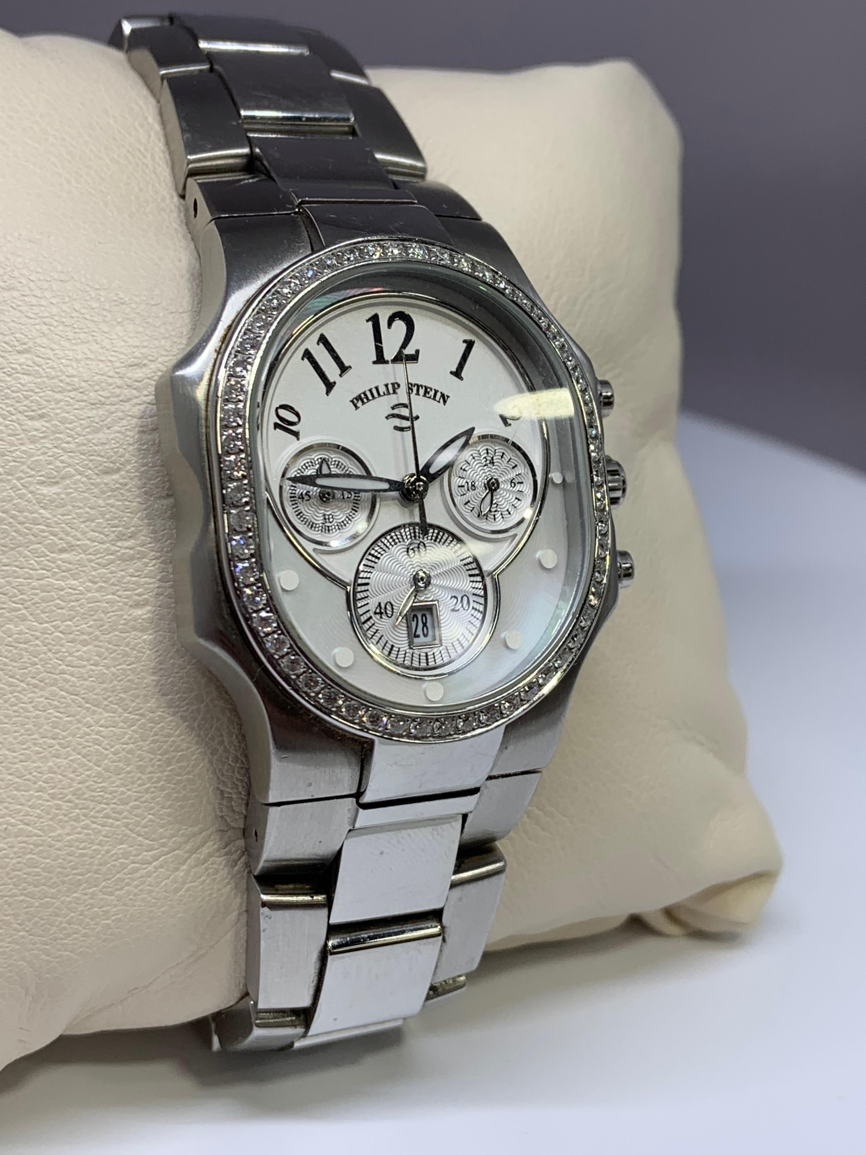 Gently used Philip Stein watch in excellent condition! This watch features a gorgeous mother of pearl detail on the face, as well as an eye-catching diamond bezel. This watch is made of stainless stell and is 3 ATM water resistant. The serial number