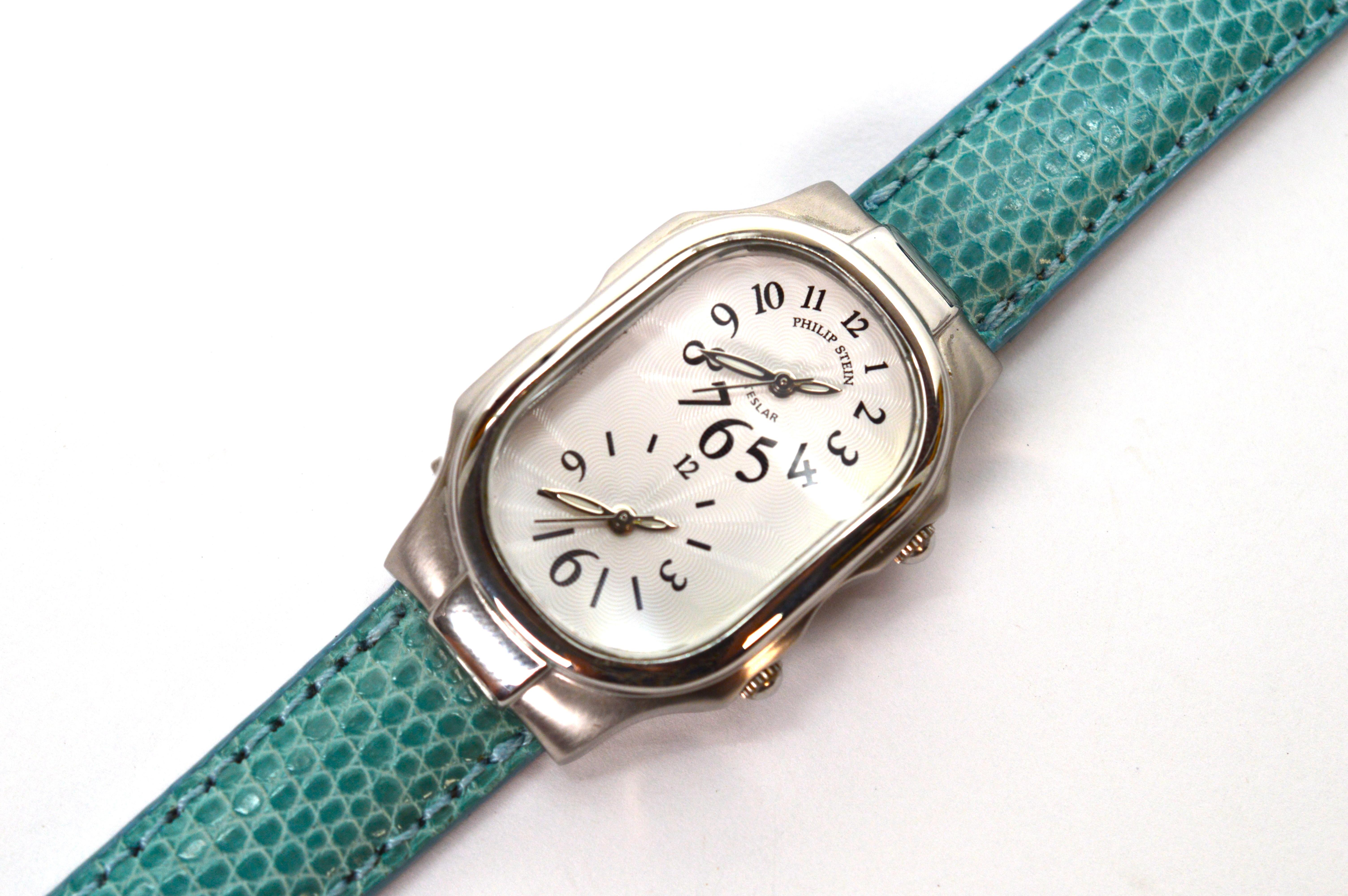 Timeless style marries innovation in this women's wrist watch by Philip Stein.  Perfect for travel and monitoring time to connect with family across the country and abroad, this smart looking quartz watch boasts an oval two dial dual time zone