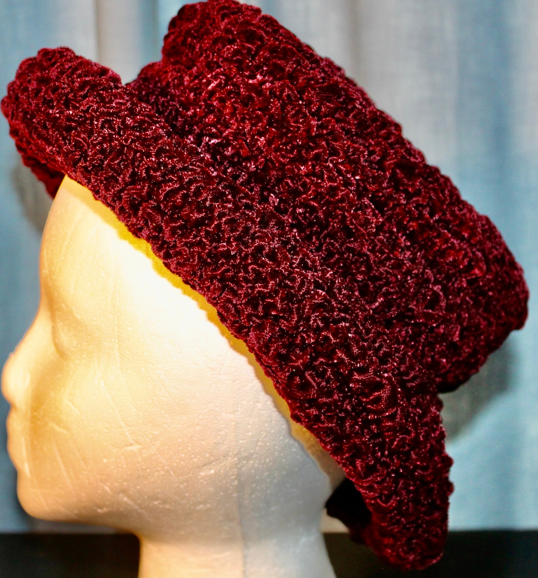 Rushed Cranberry Velvet, and Satin lining, makes a small brimmed flat top,(but soft)
hat. Measures 12 x 8