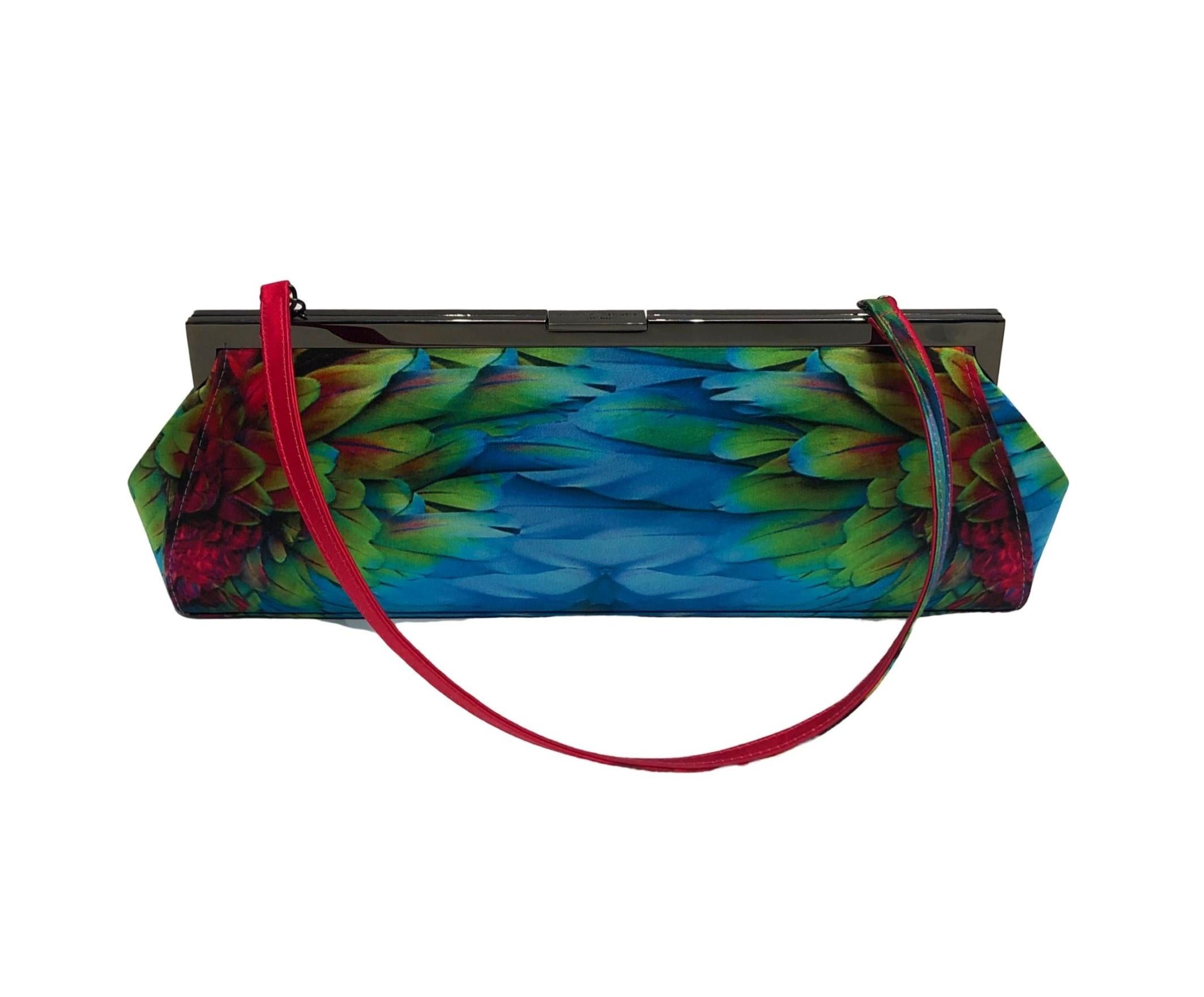 Light up the room with this incredibly vibrant Philip Treacy evening bag made from gorgeous printed silk featuring a colourful feather design, bright pink strap, gunmetal hardware and interior zip pocket.
