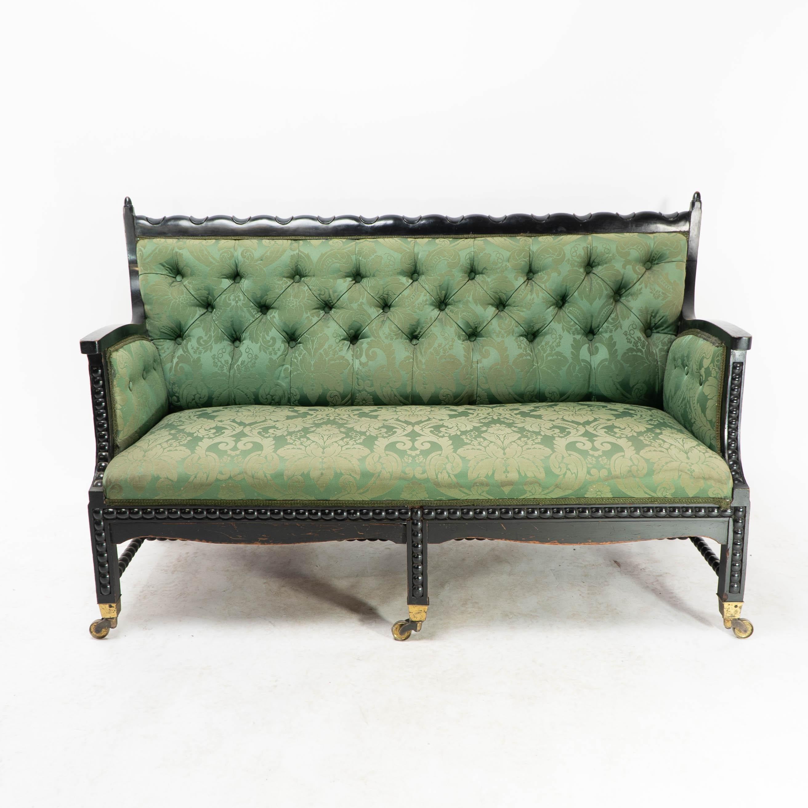 Philip Webb for Morris, Marshall, Faulkner & Co. The firm became Morris & Co in 1875.
A rare Aesthetic Movement Ebonised Settee.
Professionally re-upholstered in period-style fabric.
This settee is from the same stable as the famous bobbin-turned