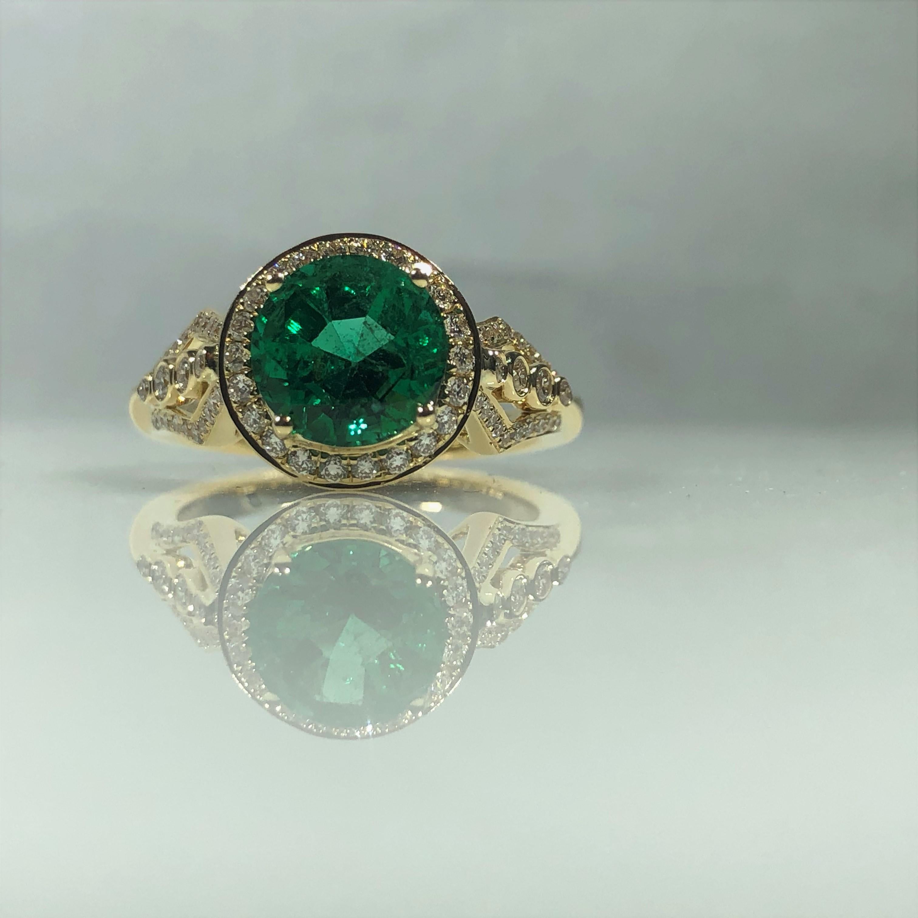 Philip Zahm Designs 18 KT 1.81 ct Round Zambian Emerald and Diamond RIng. This stunning creation is designed in 18 kt yellow gold, gold weight 5.7 grams. The Center stone is a  four prong set, round, 1.81 carat  Zambian Emerald. Emerald is 8.03mm in