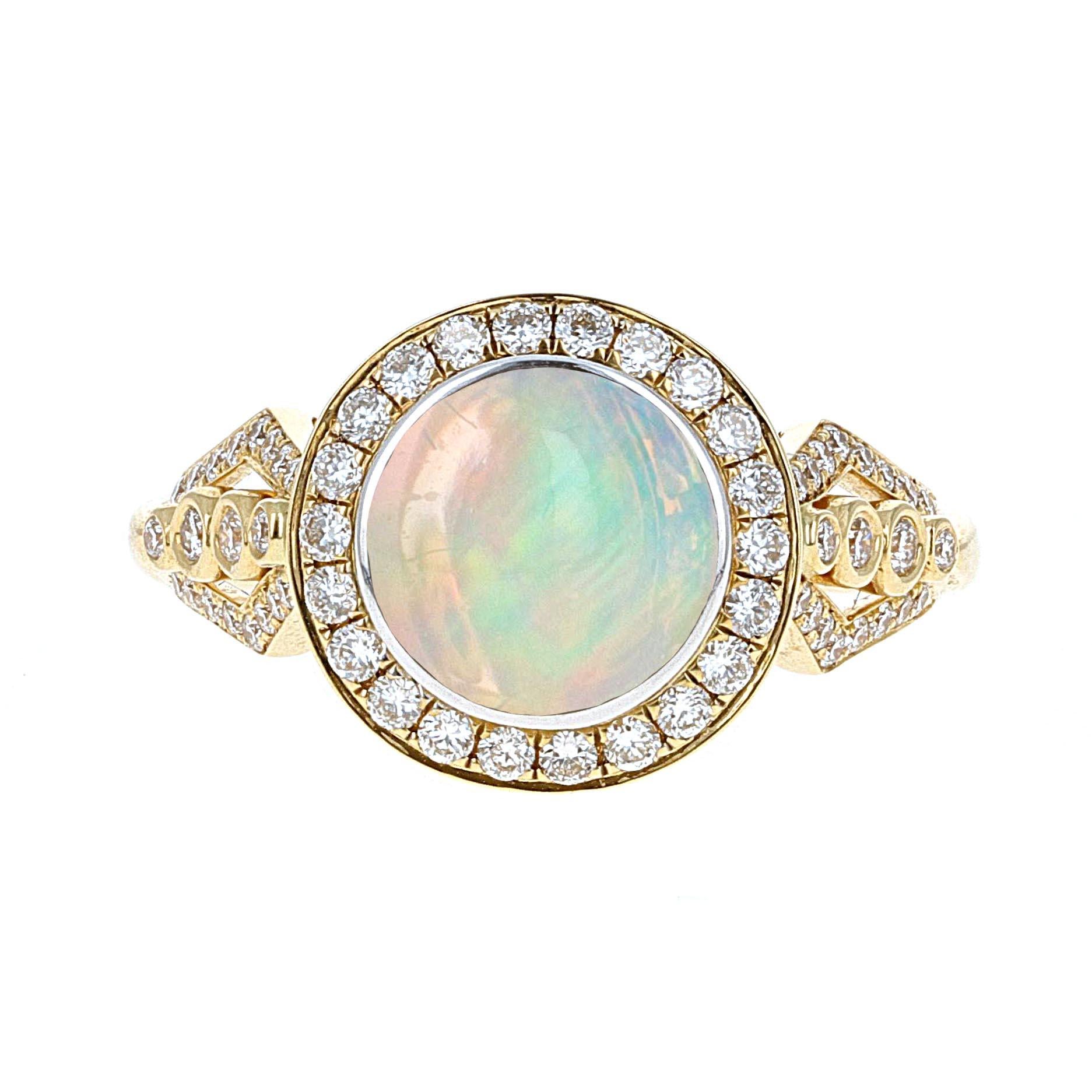 Beautifully hand made, Philip Zahm Designs, Mexican fire opal and diamond cocktail ring. The fire opal weighs 2.16 carats. The ring is made in 18 karat yellow gold and has 0.51 carats total weight in diamonds.

