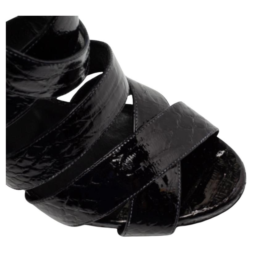 One of the most celebrated fashion House, Philipp Plein, is known for its brilliant craftsmanship in shoemaking. Crafted from python-embossed leather in a black shade, the strappy style will adorn your feet in the most beautiful way. Style them with