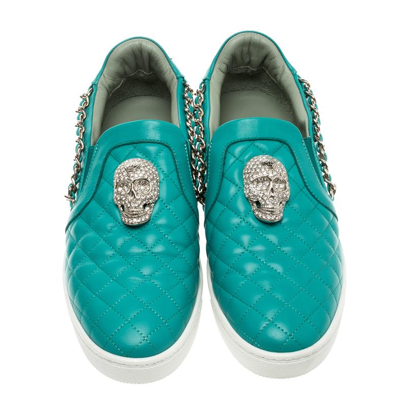 Let your latest shoe addition be this pair of turquoise slip-on sneakers from Philipp Plein. They've been crafted from quilted leather and styled with chain details and skulls embellished with crystals. They are complete with comfortable leather