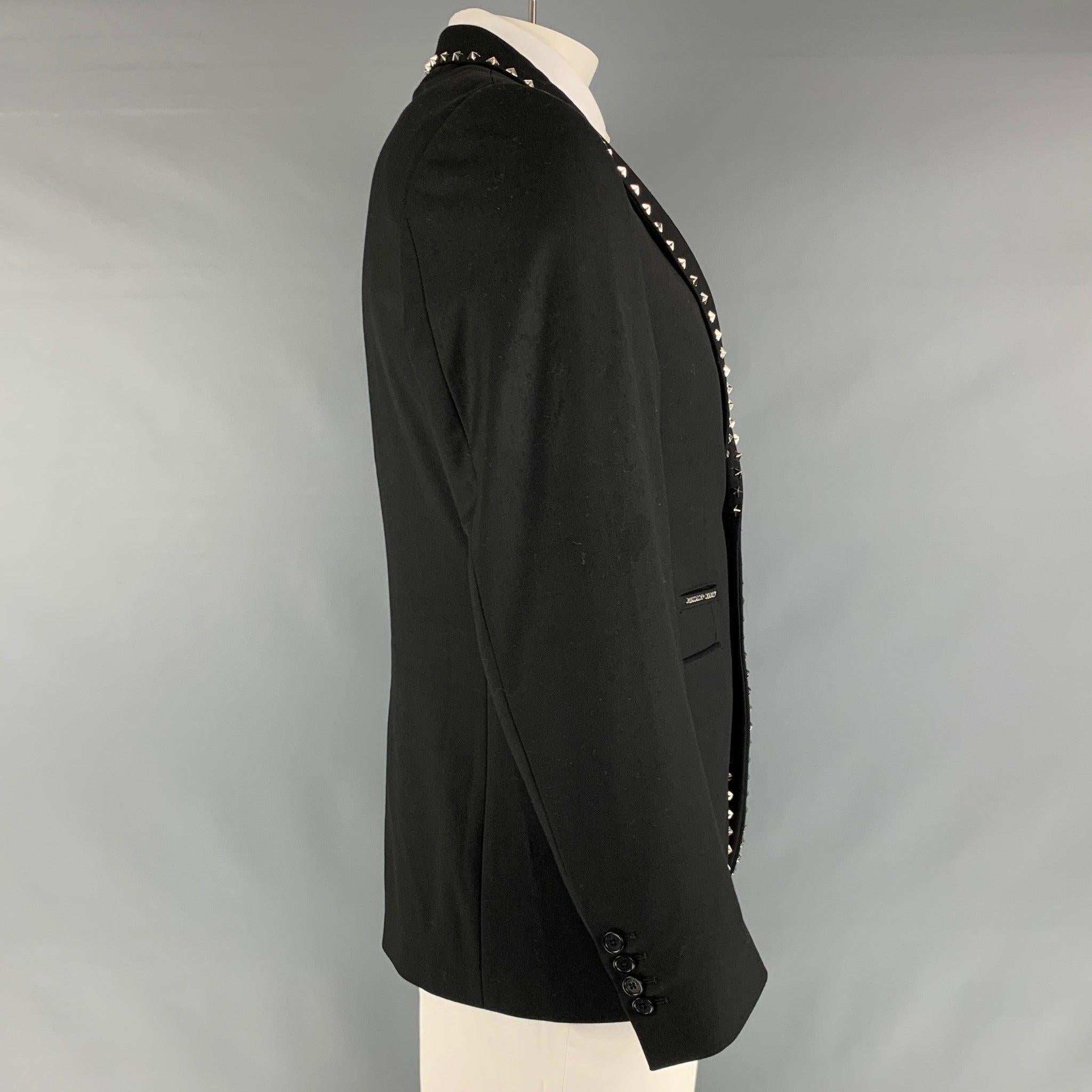 PHILIPP PLEIN sport coat comes in a black wool twill material with a full liner featuring a notch lapel, silver stars studs, single back vent, and a double button closure. Made in Italy. Very Good Pre-Owned Condition. Minor mark inside at lining.