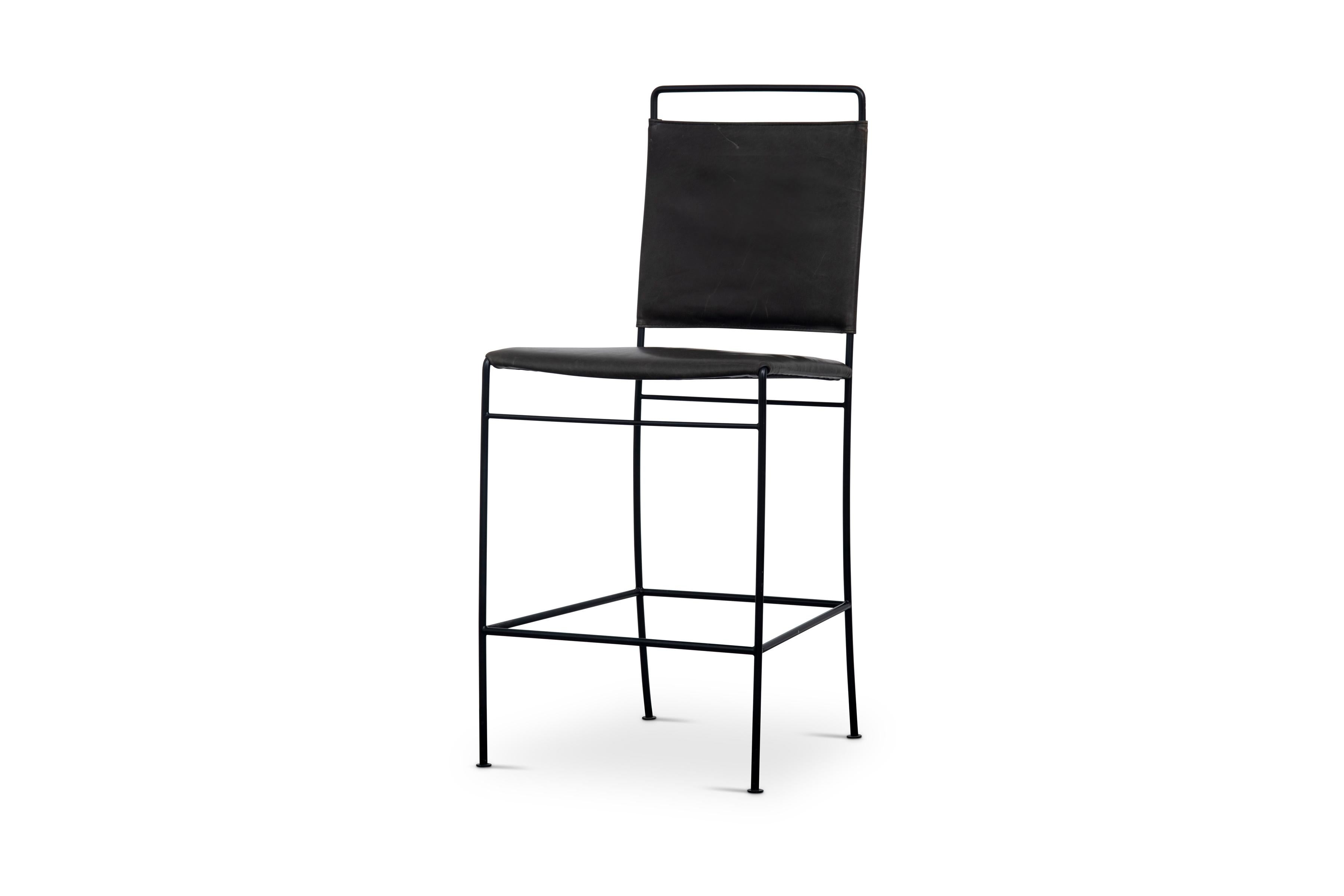 The Philipp Tall Chair has a blackened steel frame with a tight wrapped leather seat and back in Espresso Buffalo Leather. Cross stretchers offer stability and the legs are finished with coin-shaped tabs.

The chair frame is also available in