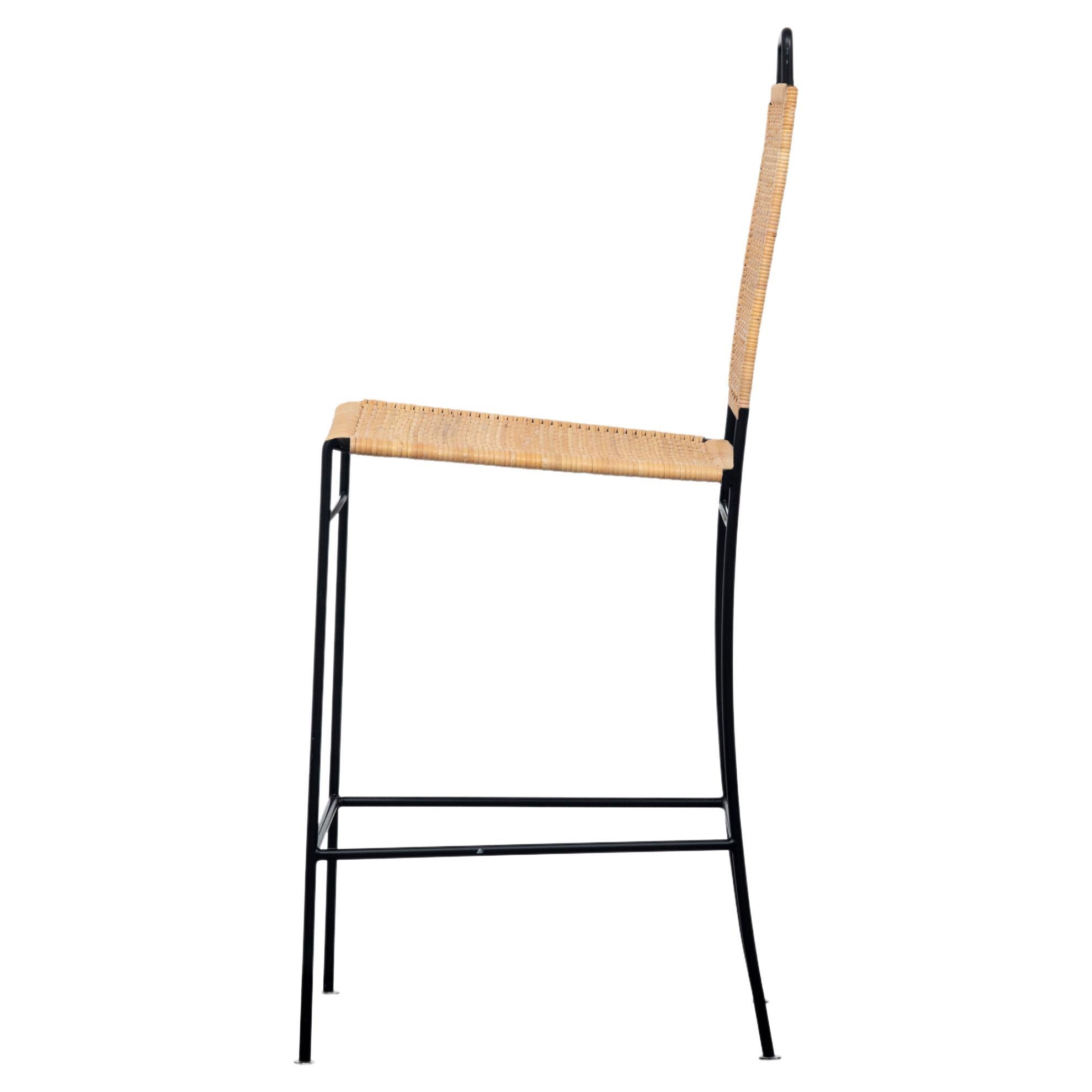 The Philipp tall woven chair has a blackened steel frame with a handwoven back and seat of natural rush. Cross stretchers offer stability and the legs are finished with coin-shaped tabs.

The chair frame is also available in stainless
