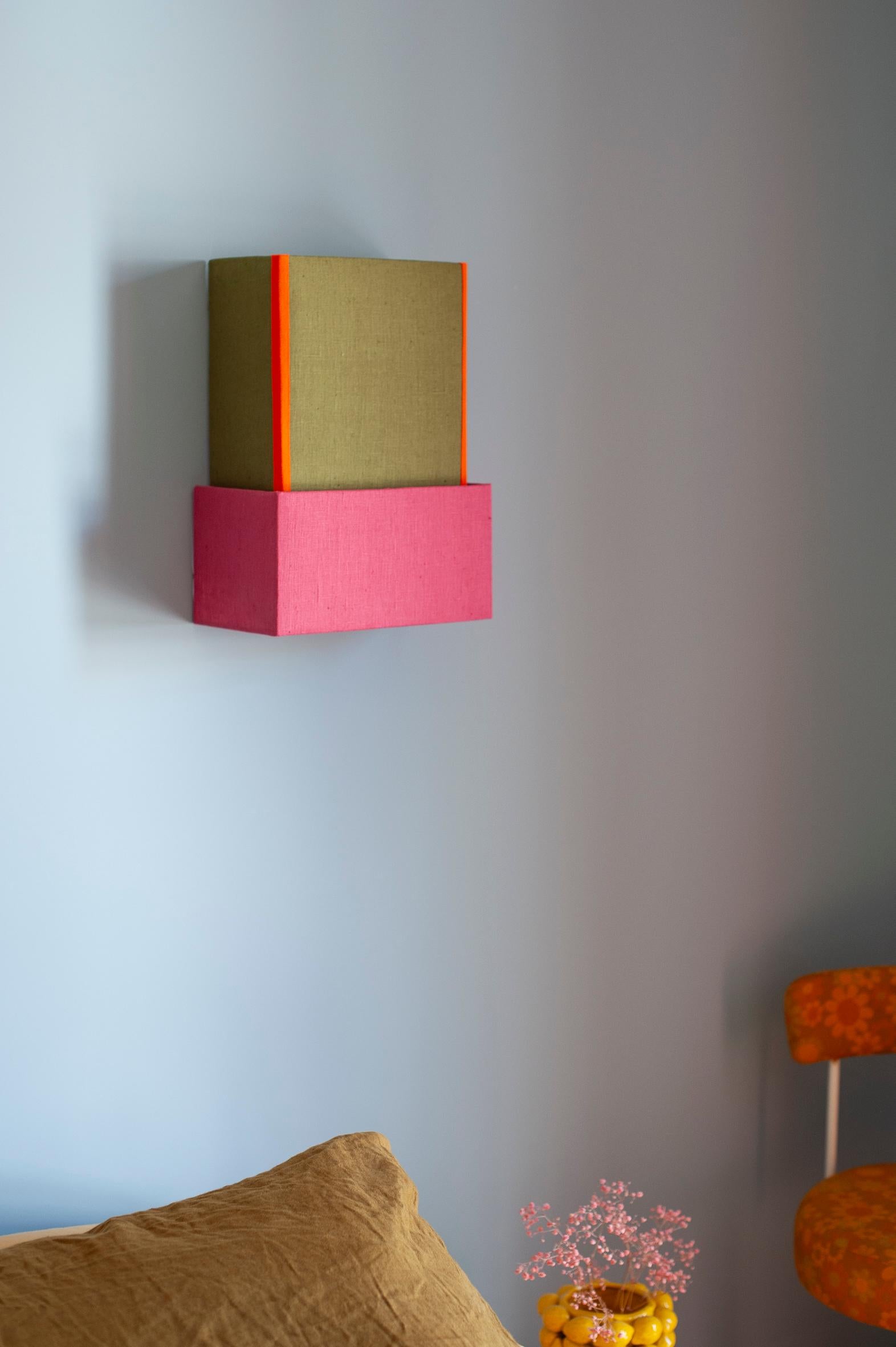 REVERSIBLE WALL LIGHT / handcrafted in Bordeaux, offered in limited edition

Colour: Khaki, pink & orange

Material: Linen & cotton

Dimensions: H40 / L30 / D15

Mounting: Attaches to the wall using a metal bar located on the back of the