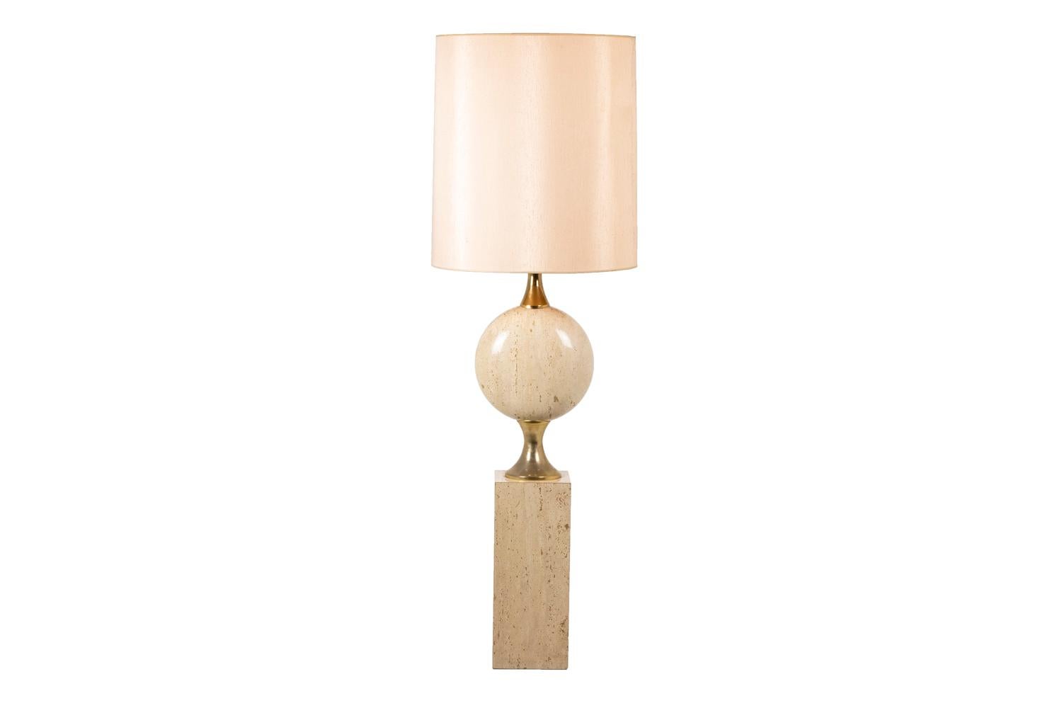 Philippe Barbier, attributed to. 

Lamp composed of a rectangular base and a central flattened sphere in travertine. The two parts are linked by mounts in gilt brass. Lampshades in fabric.

Work realized in the 1970s.
  