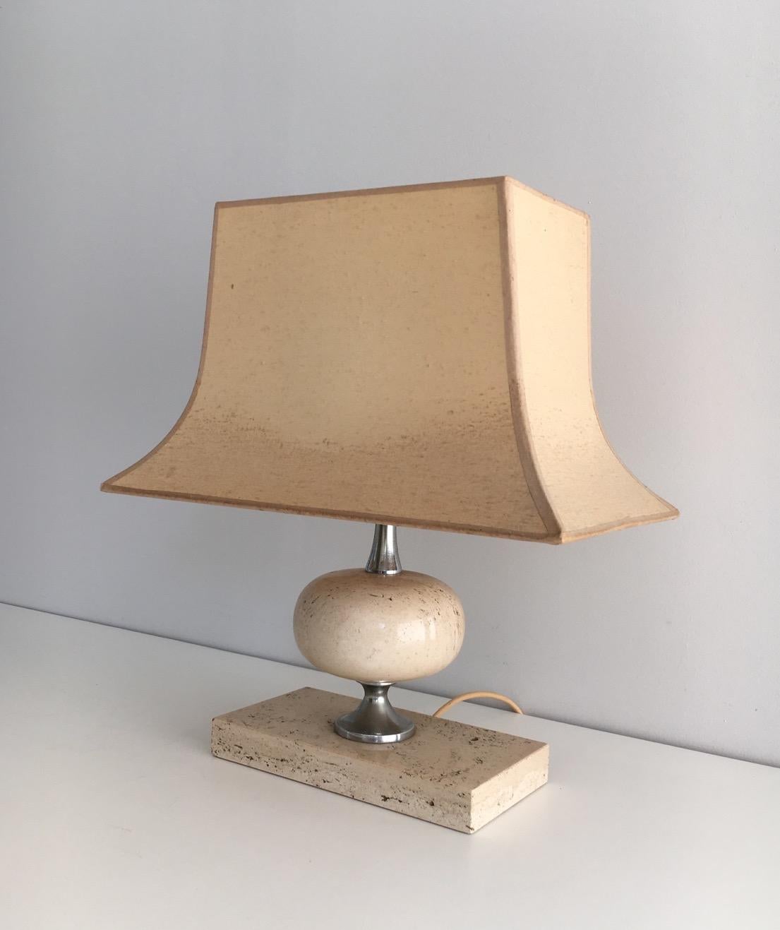 This table lamp is made of travertine and chrome. This is a Philippe Barbier lamp, circa 1970.