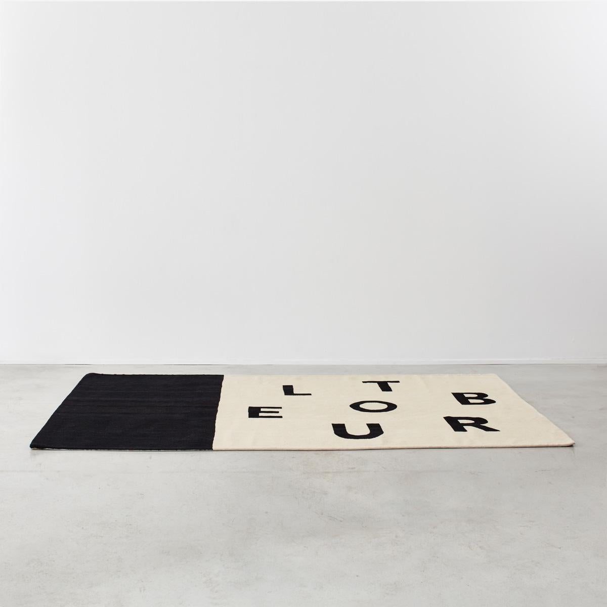 A limited edition, hand-woven rug from Chevalier Édition by the French artist Philippe Cazal (1948-present). Cazal’s work, which is owned by the Pompidou Centre among other collections, explores the power of the written word, especially how