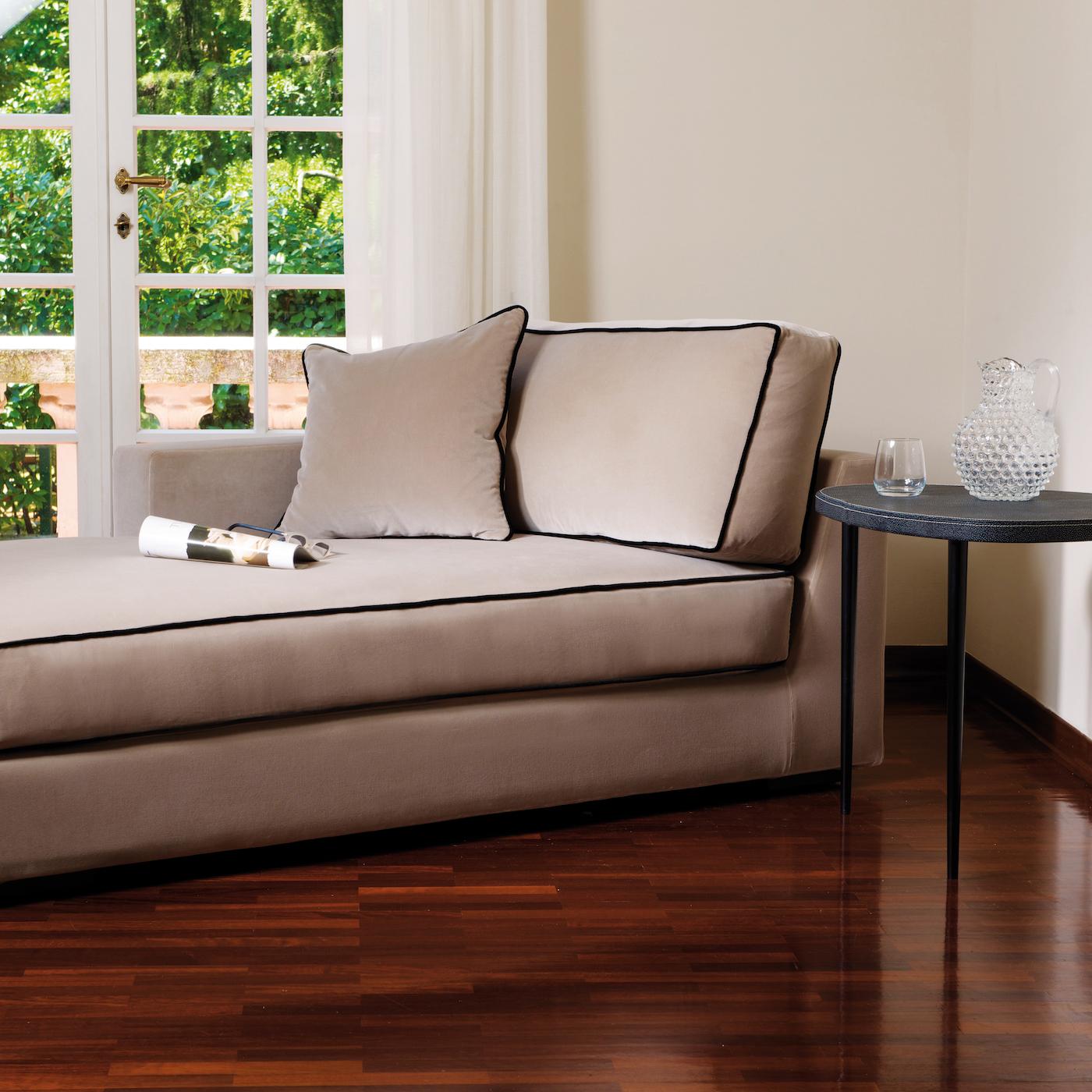 A superb addition to a contemporary or classic home, this chaise longue is a celebration of sophisticated lounging. The wooden structure is visible in the lacquered feet that support the plush base padded with a combination of goose down and