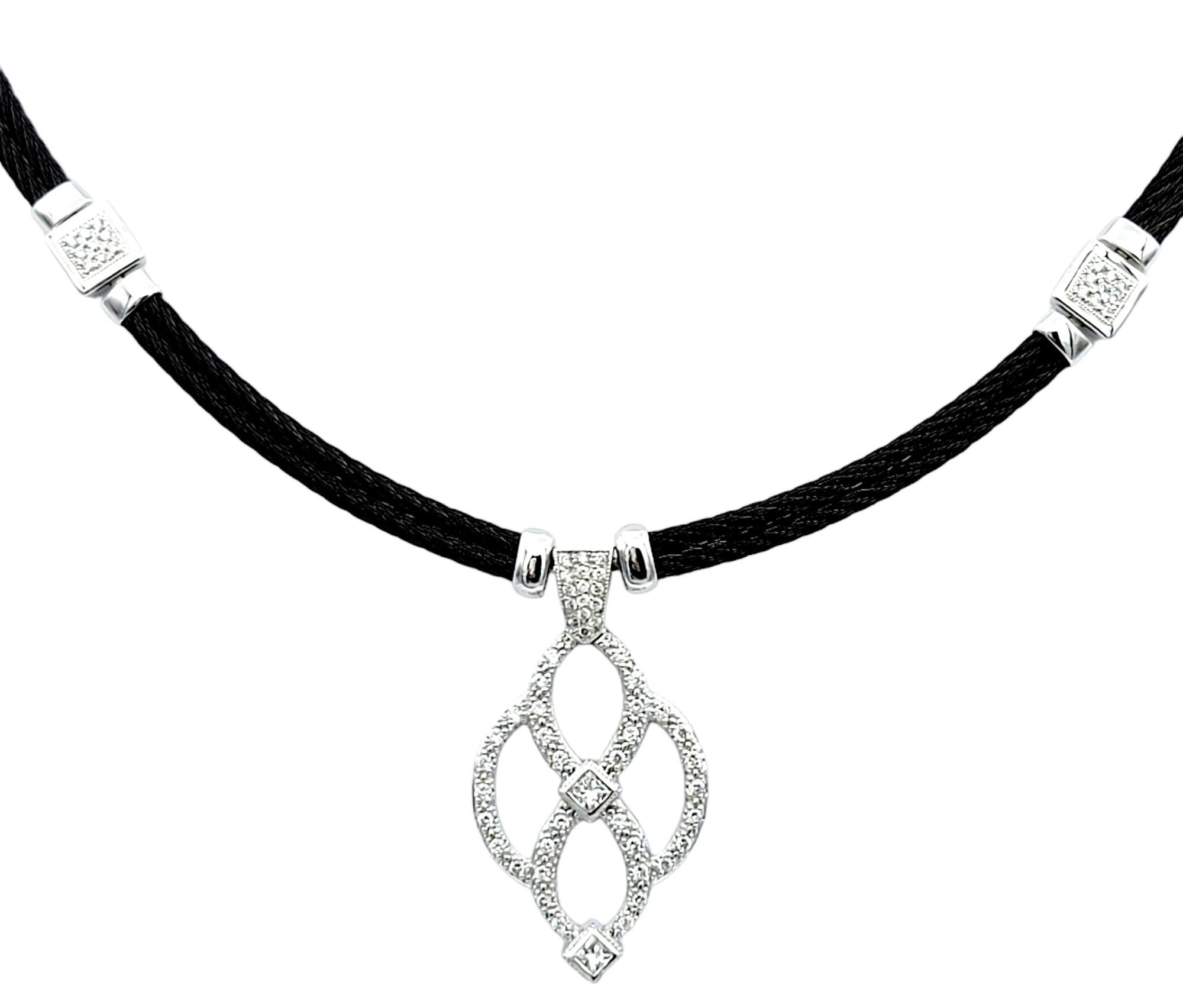 This gorgeous Philippe Charriol Celtic Noir diamond station necklace seamlessly blends contemporary elegance with timeless Celtic motifs. Crafted with meticulous attention to detail, this necklace features a black stainless steel cord adorned with