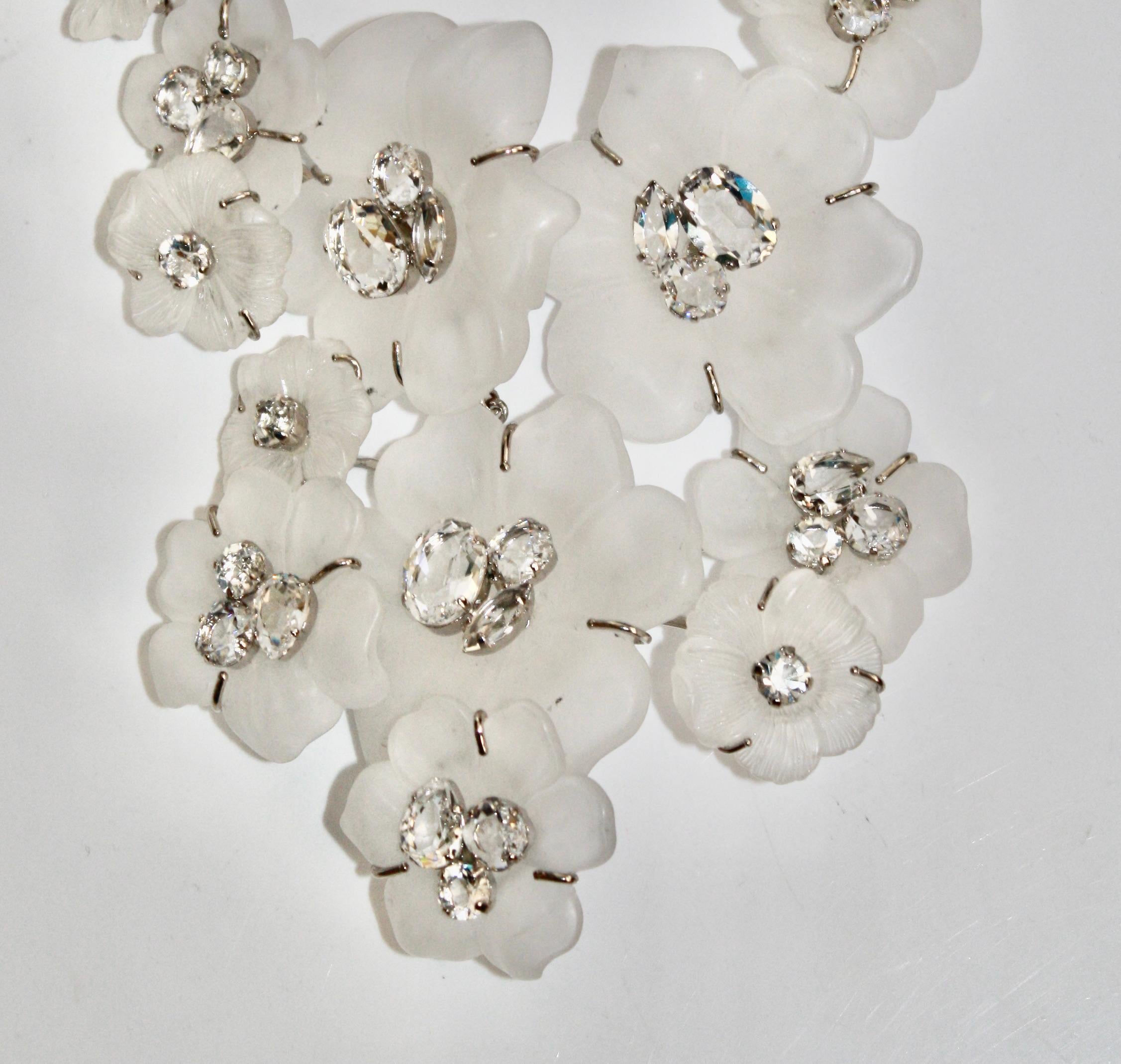 Statement necklace with beautifully molded frosted acrylic flowers. Swarovski crystal pistil on each flower.
Diameter can expend from 5